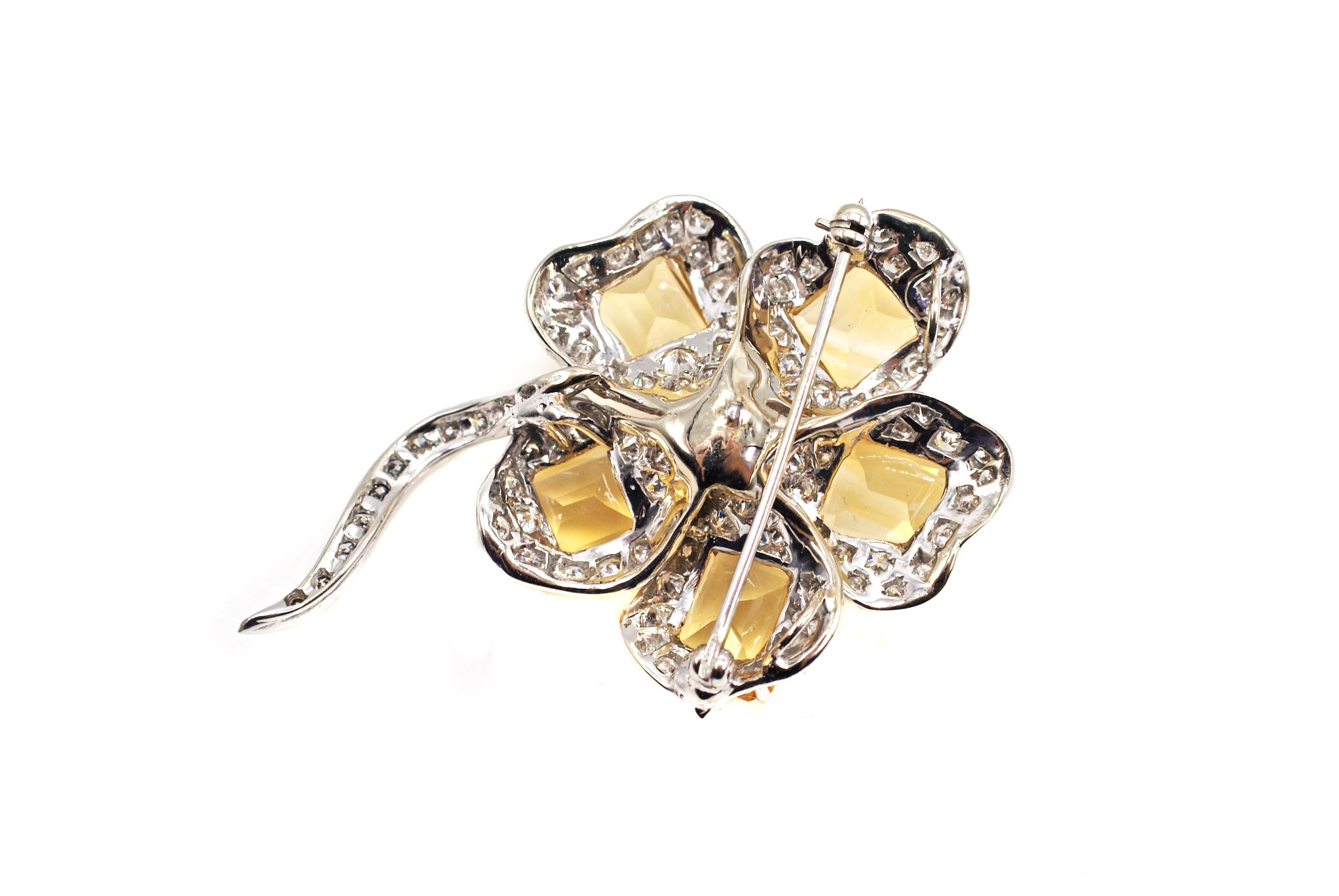 This beautifully designed and well hand-crafted flower brooch from ca. 1960 is worked in a wonderful three dimensional and true-to-nature fashion. Each of the petals is set with a perfectly matched bright yellow emerald cut citrine while the but