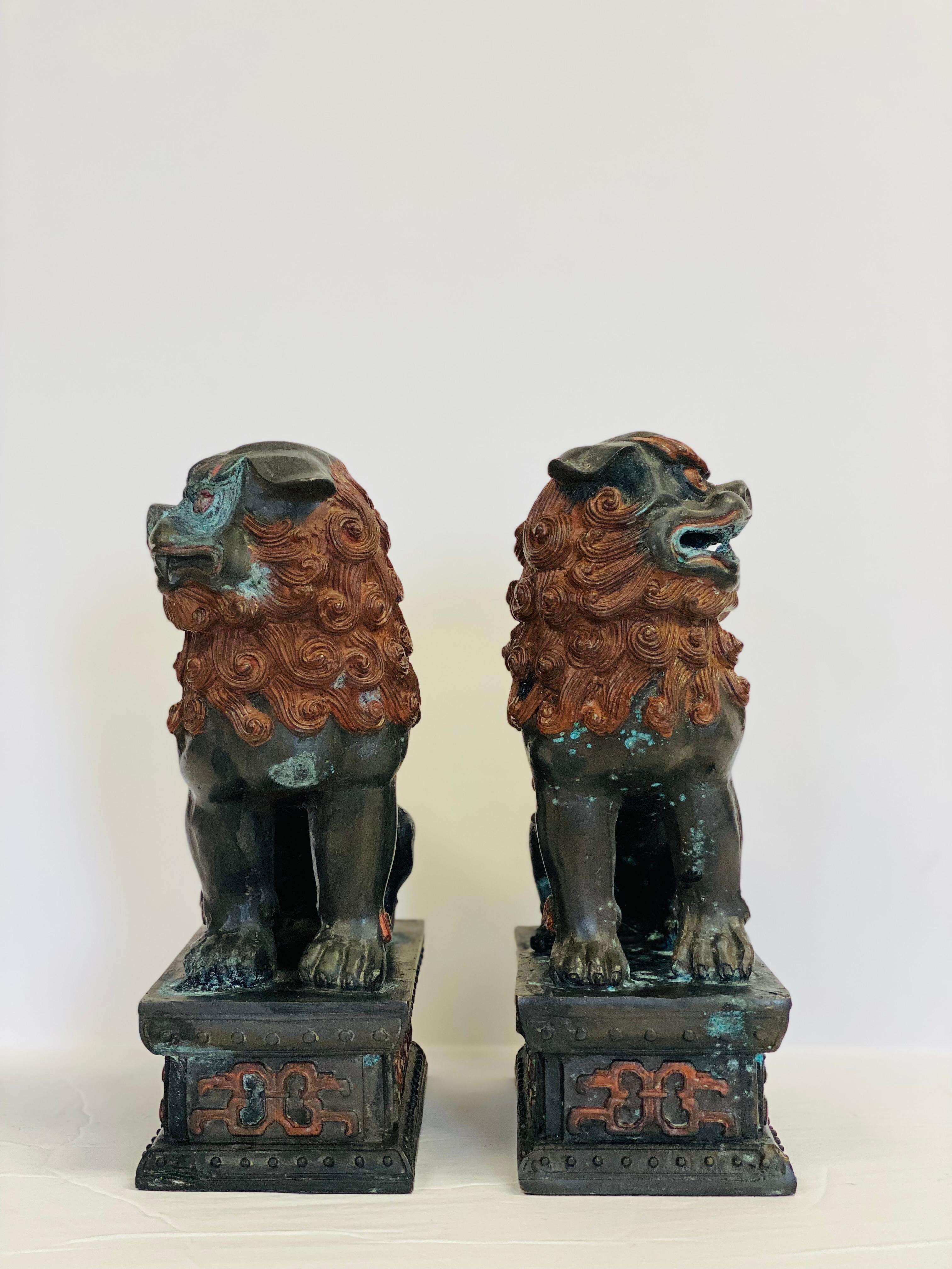 We are very pleased to offer an exquisite pair of foo dog bookends, circa the 1960s. Traditional Eastern culture blends with timeless style in this unique set of heavy-weight cooper Chinese guardian lions. The natural changes that happen to copper