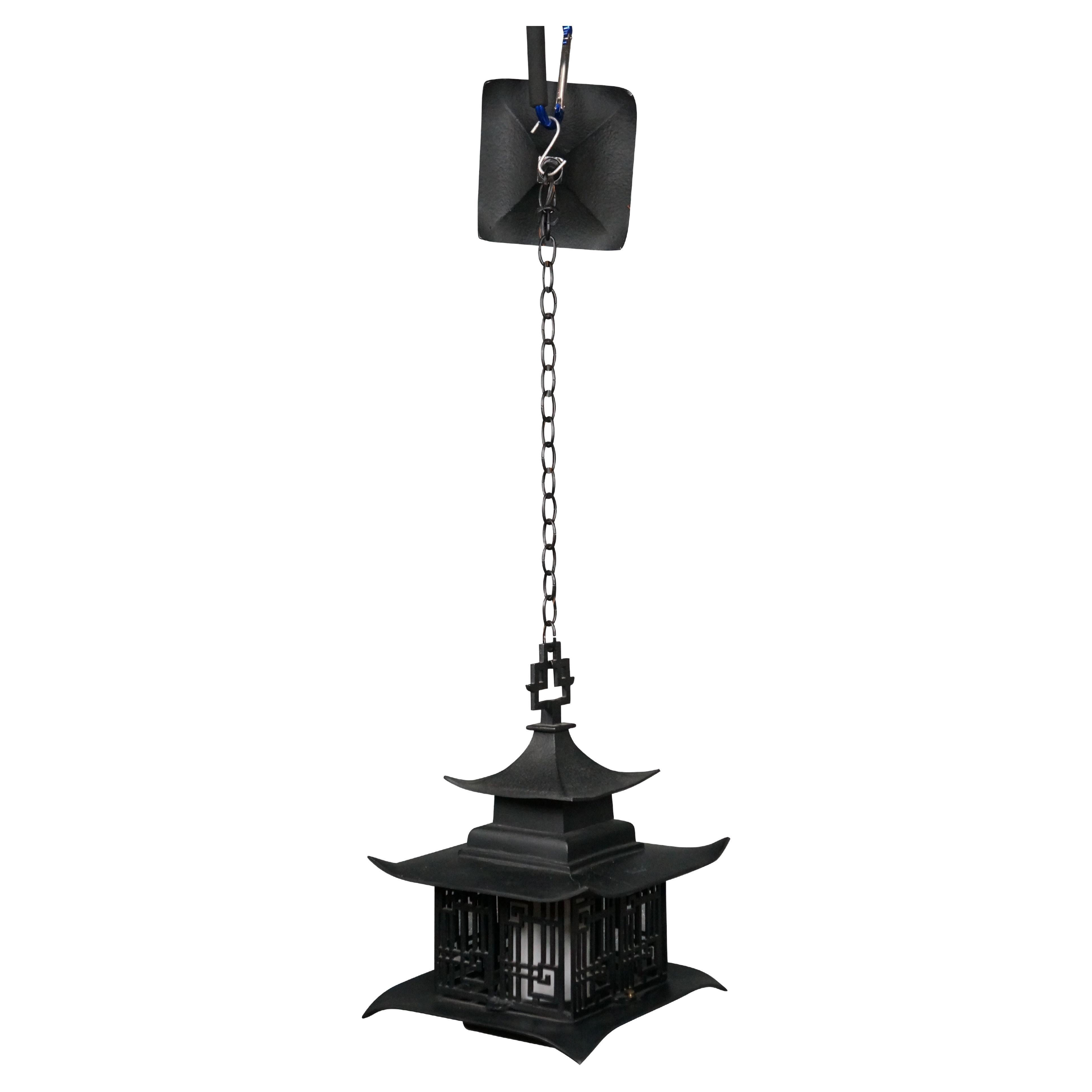 Circa 1960's black metal single light, hanging lantern / pendant light. Pagoda style lantern with a pierced chinoiserie cage around a white glass hurricane shade.

Dimensions:
12.5