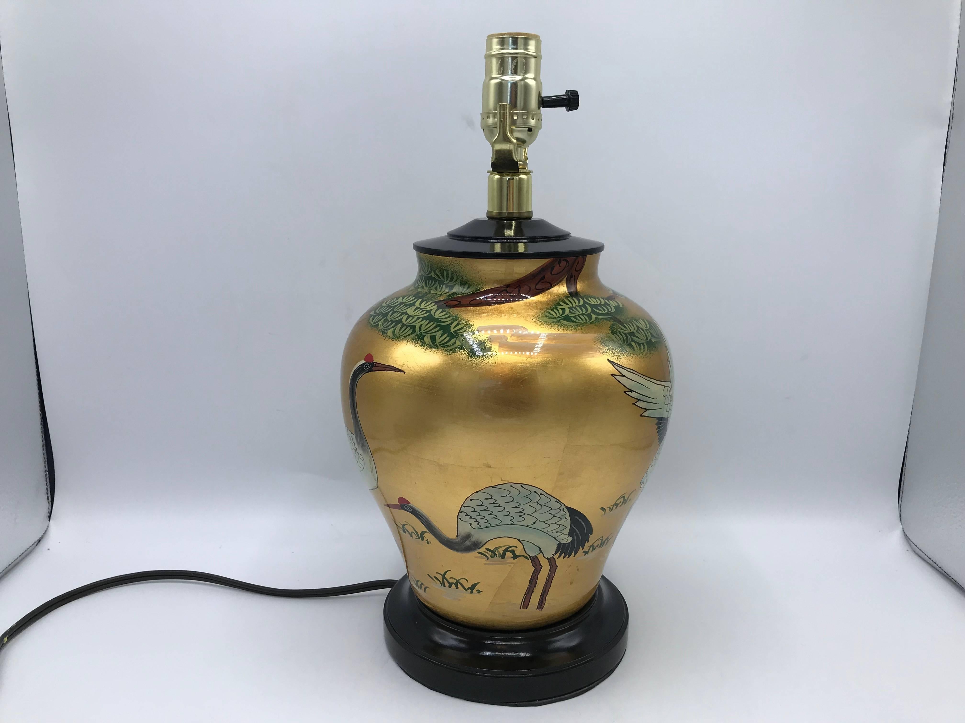 Offered is a fabulous, 1960s black and gold, Chinoiserie table lamp with an ornate lacquered crane motif. Newly rewired.