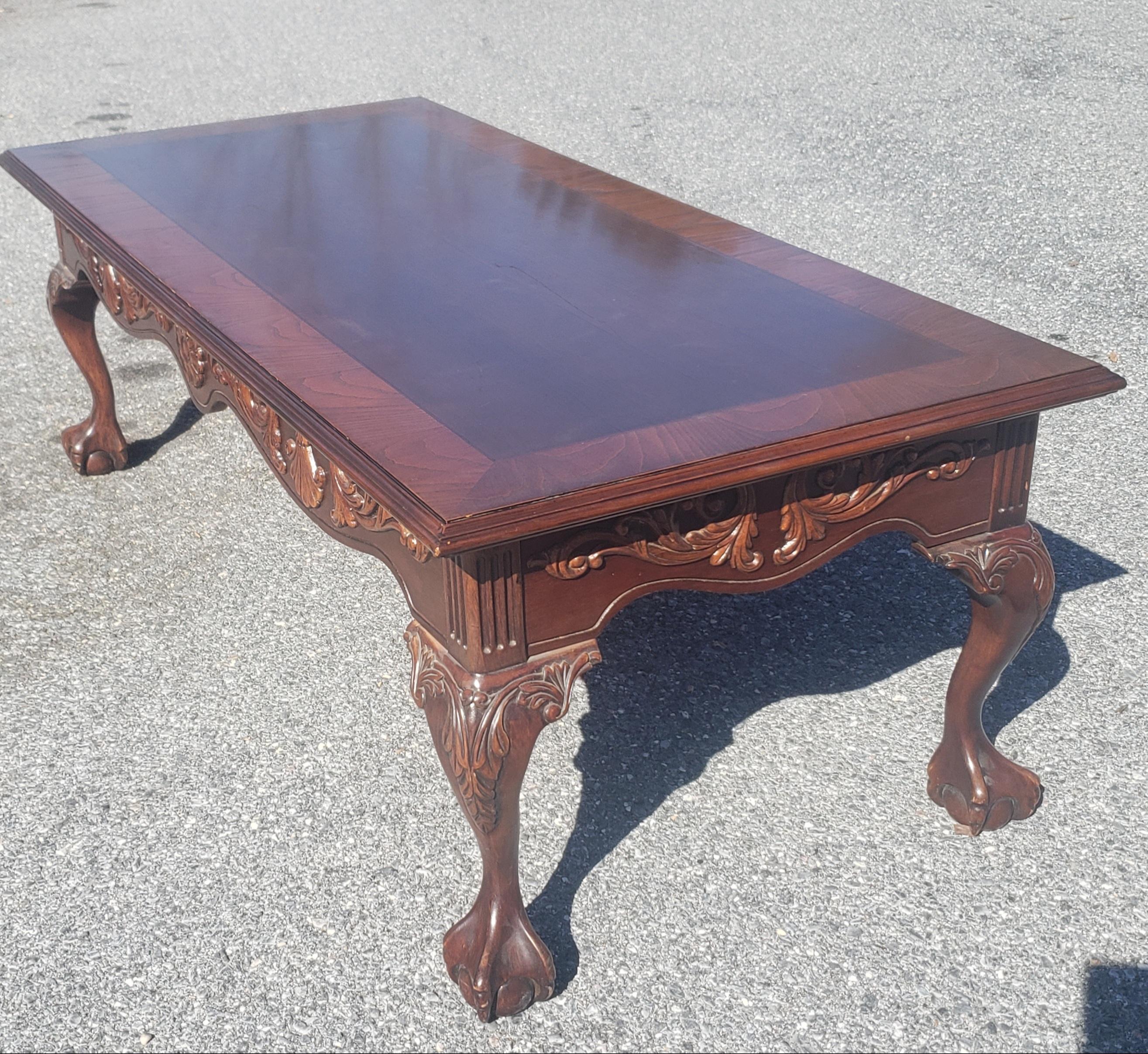 1960s Chippendale style banded top and carved apron mahogany with ball claw feet coffee table.
Measures: 52