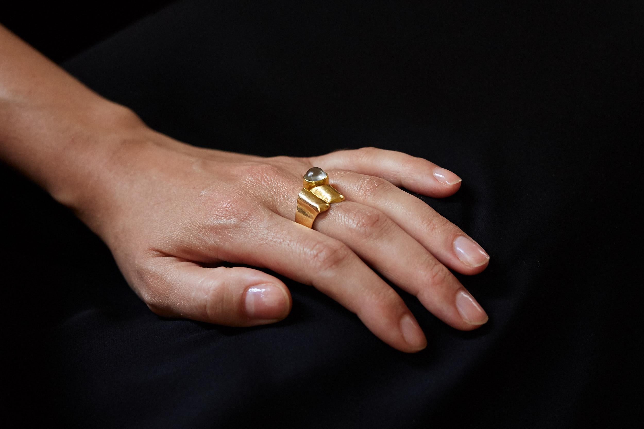 A moonstone and 18 karat gold modernist ring, by German, Cologne-based jeweler Christa Bauer, c. 1960.

Size 7.5. The ring is stamped with maker's mark and 750.