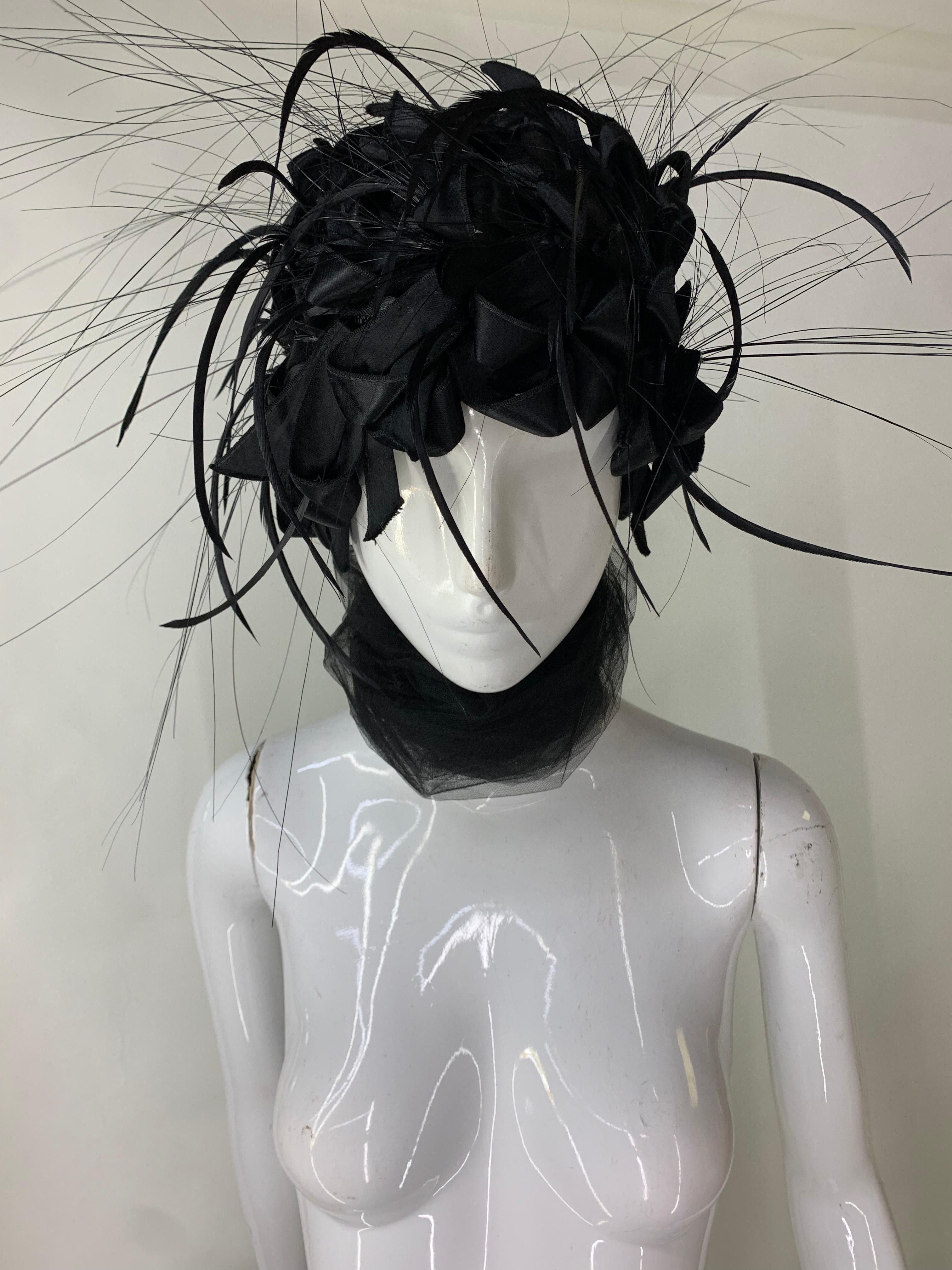 1960s Christian Dior Black Silk Ribbon and Feather Turban w Attached Tulle Scarf:  Lined in black tulle, this turban is a softer construction, not stiff at all. Ribbon loops and feather wisps adorn the hat. An attached silk tulle scarf can be styled
