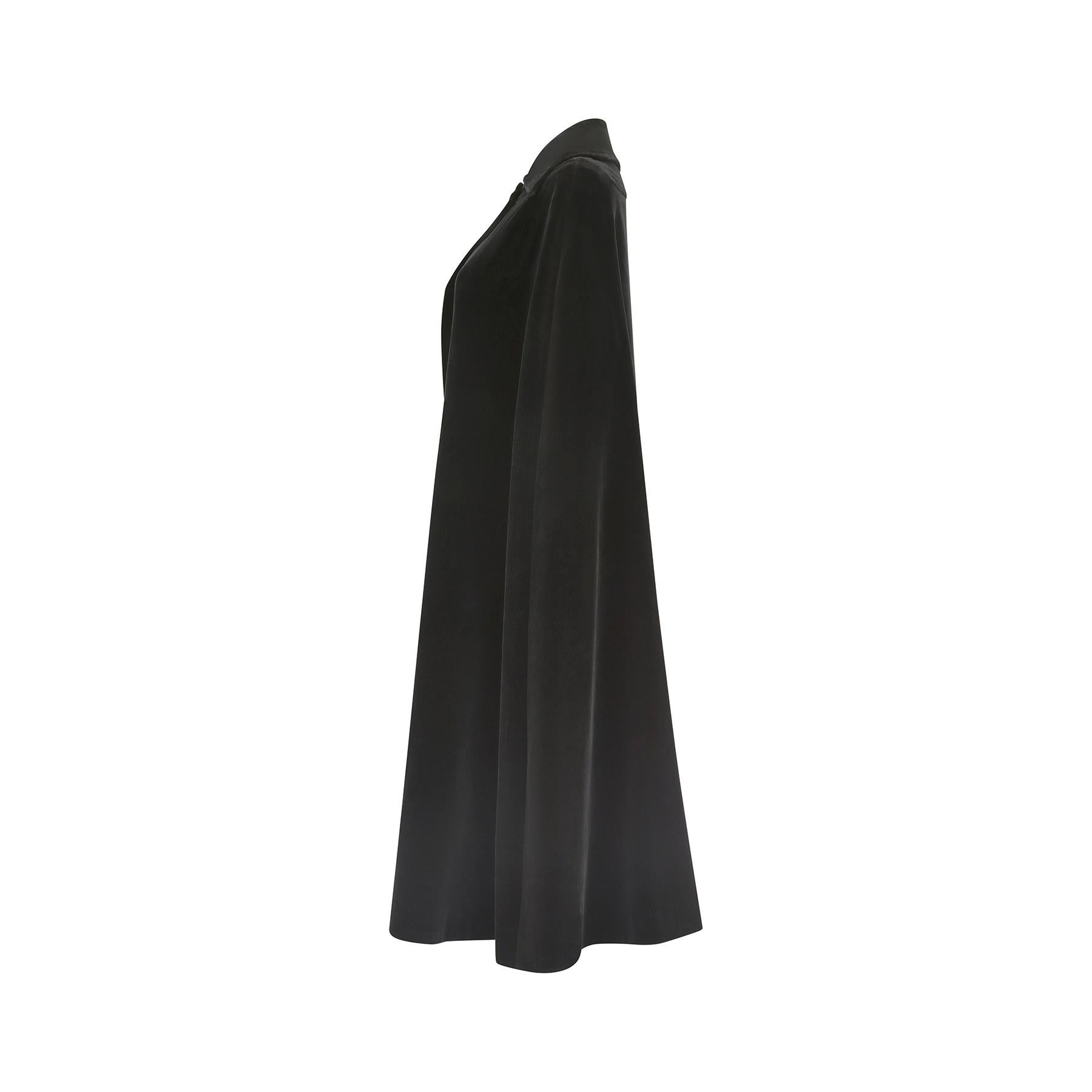 This late 1960s Diorling by Christian Dior cape is made from an incredibly thick and luxurious black velvet. It fastens at the collar with a popper closure and really evokes the chic silhouettes of the 60s, with capes often having been worn over