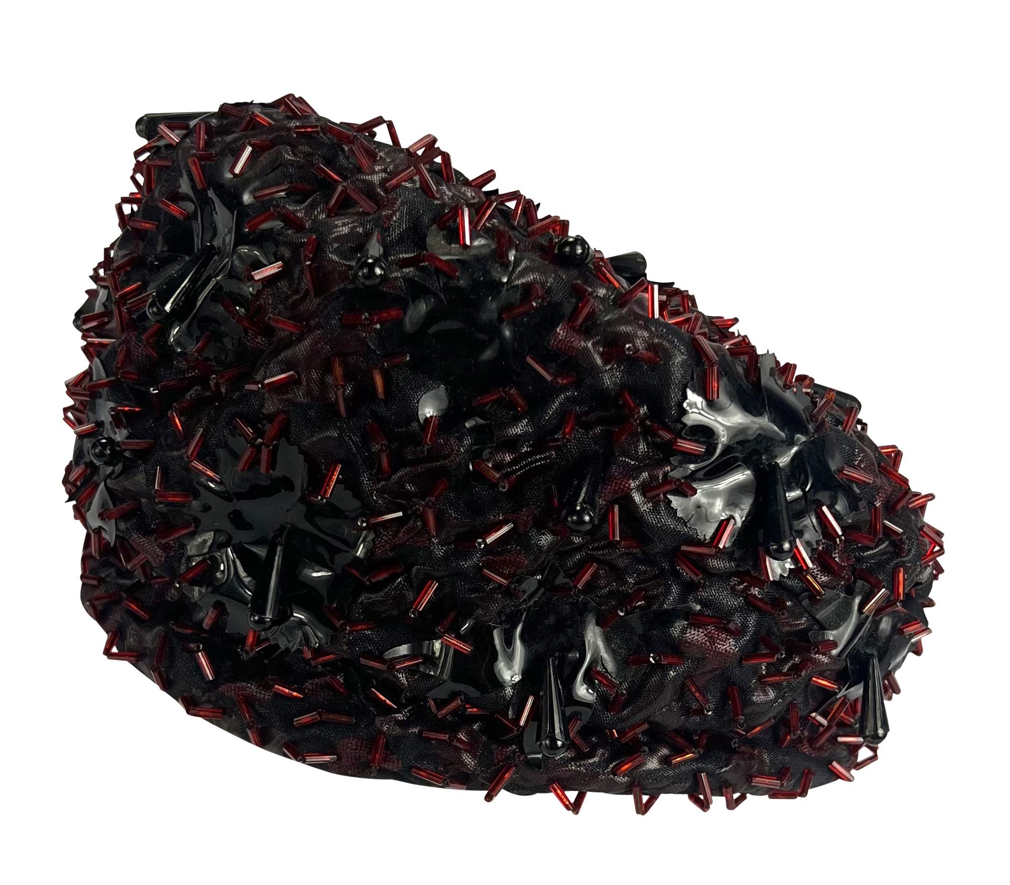 Presenting a fabulous black vintage Christian Dior beaded turban-style hat. From the 1960s, this hat is covered in red and black beads and is the perfect chic addition to any wardrobe! 

Approximate Measurements: 
Height: 5.5