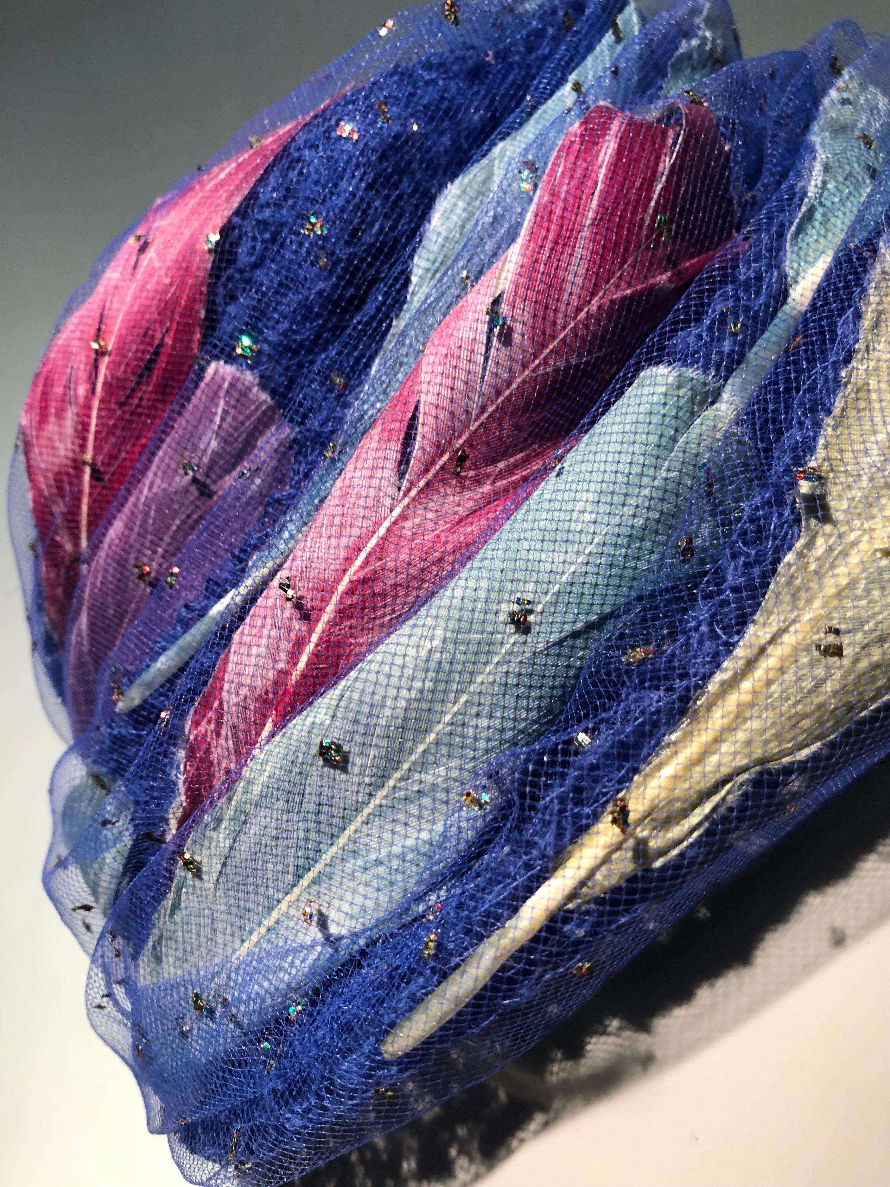 A fabulous 1960s Christian Dior turban-styled hat in cobalt blue felt and pink, white and blue feathers enclosed in glitter studded tulle! This is one of Dior's signature looks!! Originally sold at Lord and Taylor.