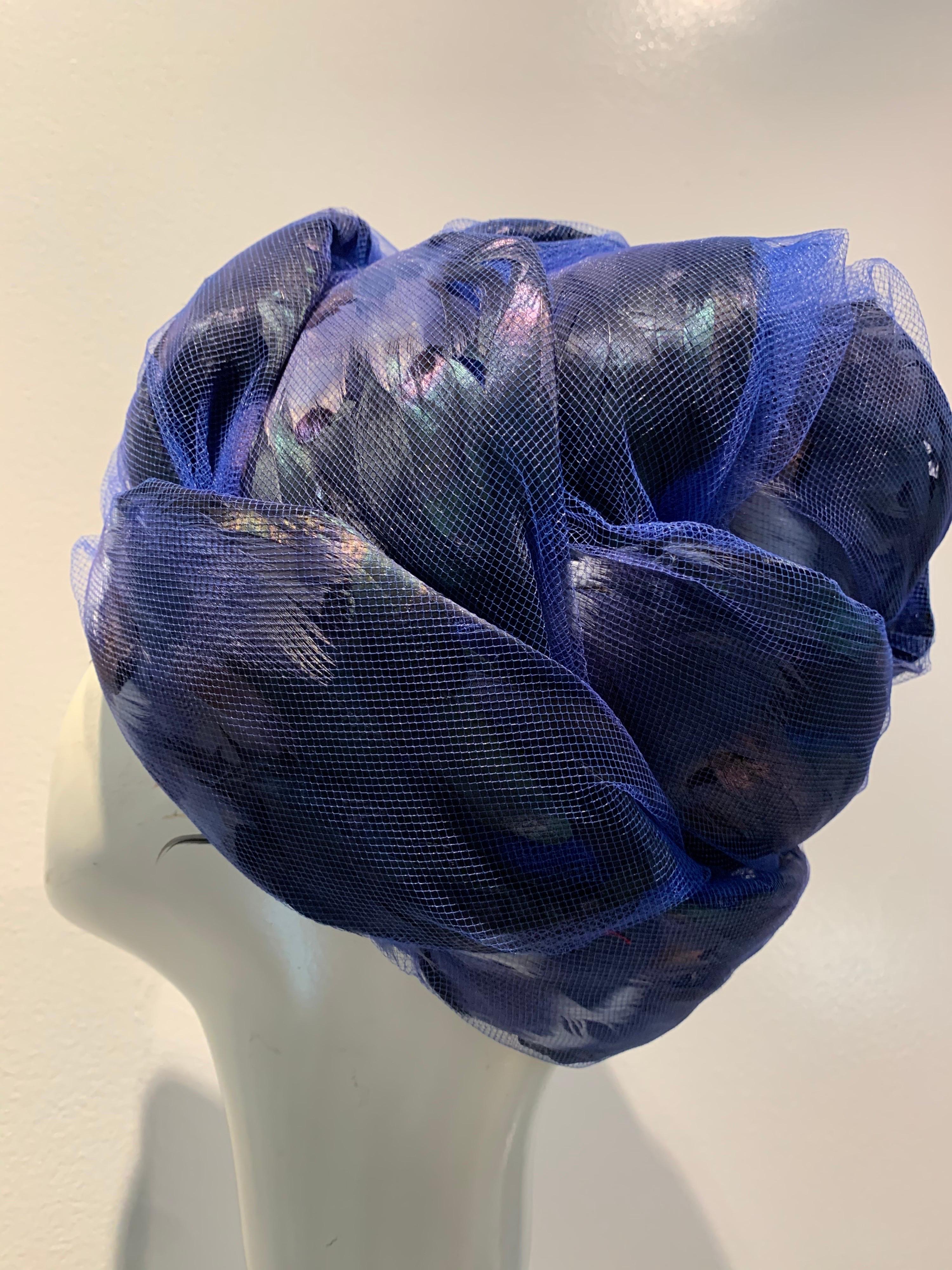1960s Christian Dior cobalt tulle and feather beehive shaped turban-style hat.  Feathers are iridescent black, blue and pale blue arranged in petal shapes encased in tulle. Size Medium 