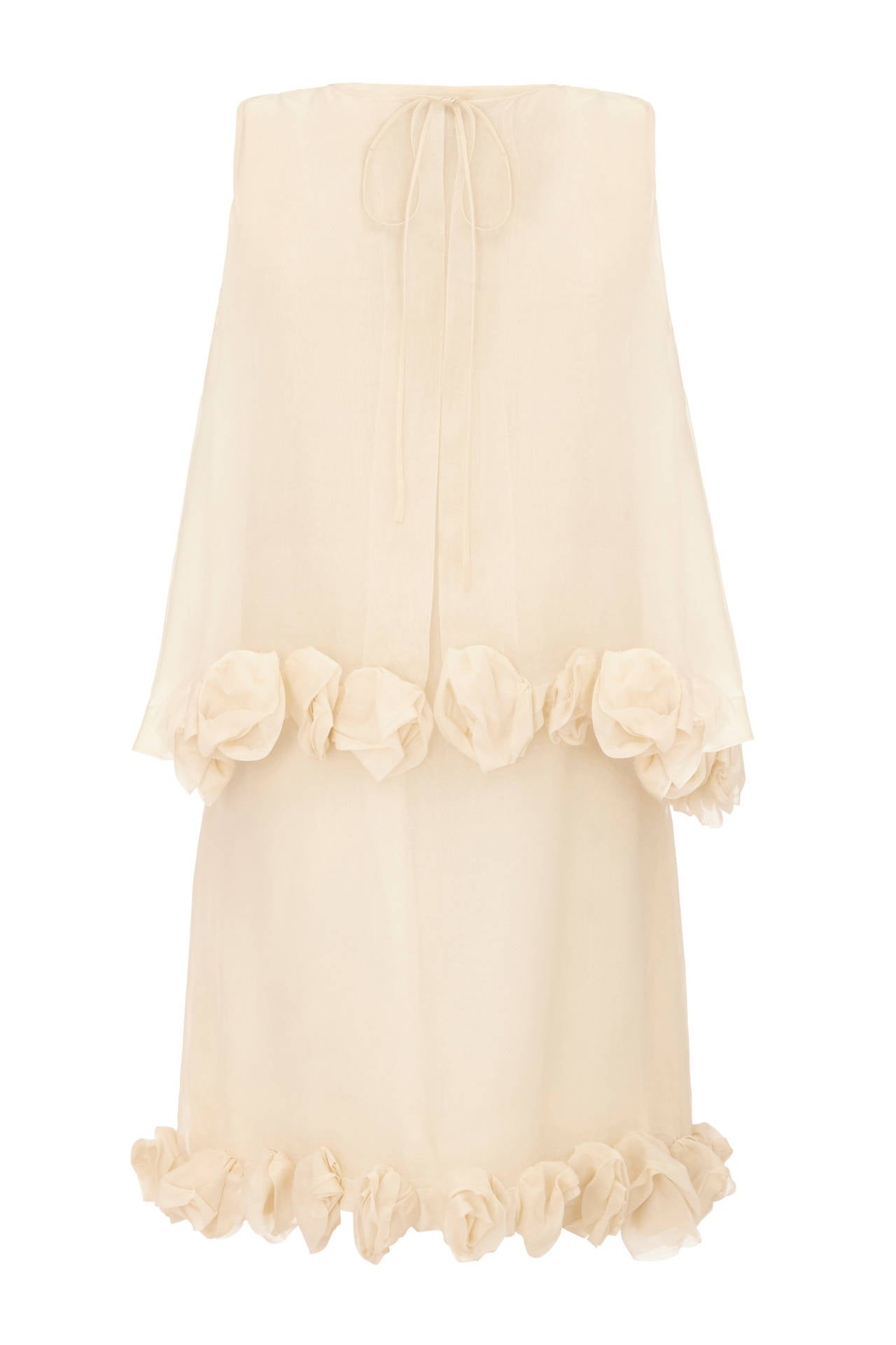 Sensational ivory silk organza dress and sleeveless jacket set with sculptural 3D organza roses around the hems. This vintage 1960s piece by Christian Dior is couture made and would make a fantastic alternative bridal outfit. It is in very good to