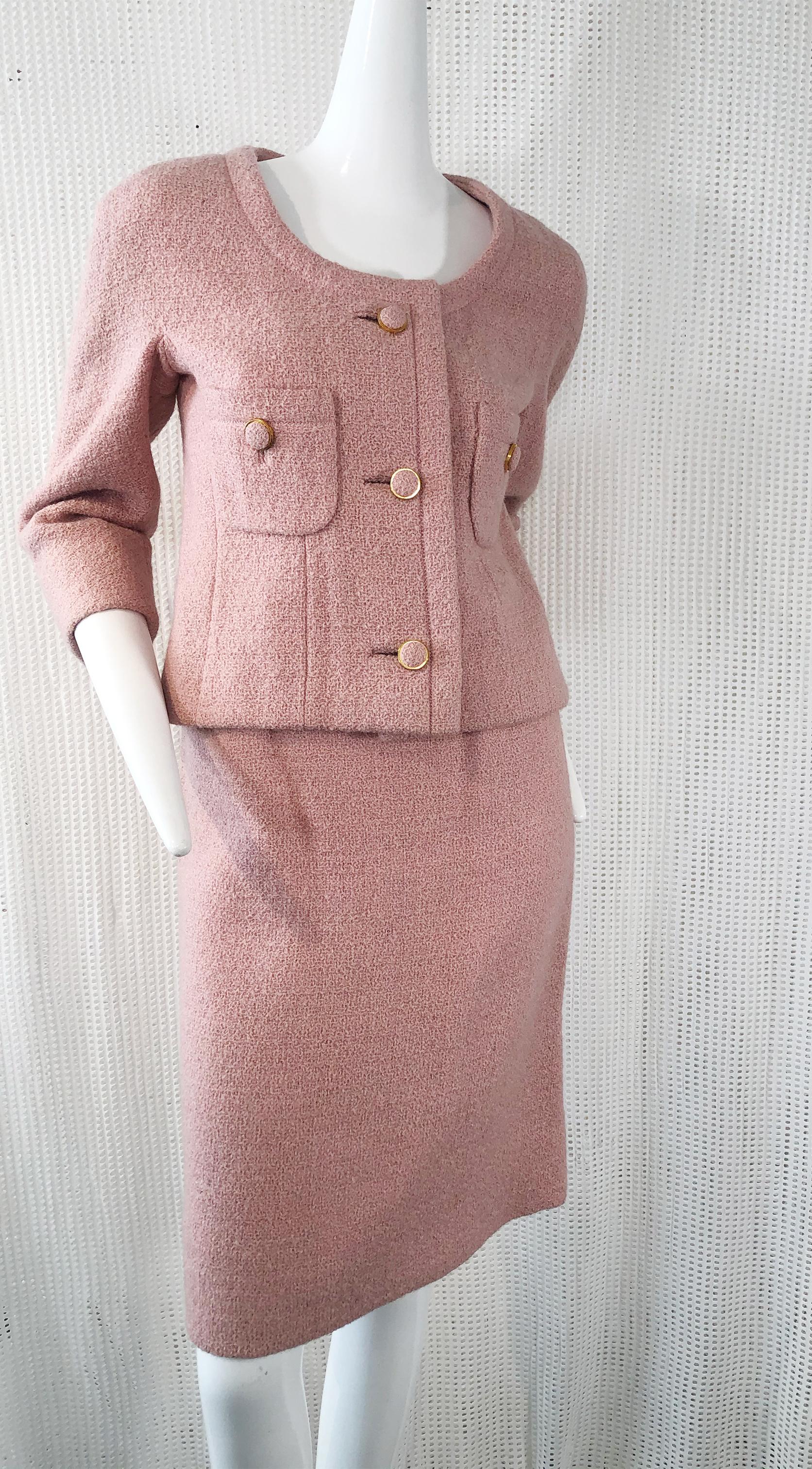 An exquisite 1960s classic Christian Dior dusty rose spring-weight wool bouclé mini skirt suit. Collar-less, classic design in a Chanel style with front applied pockets and covered buttons. Fully lined, of course. Skirt is just above the knee in a