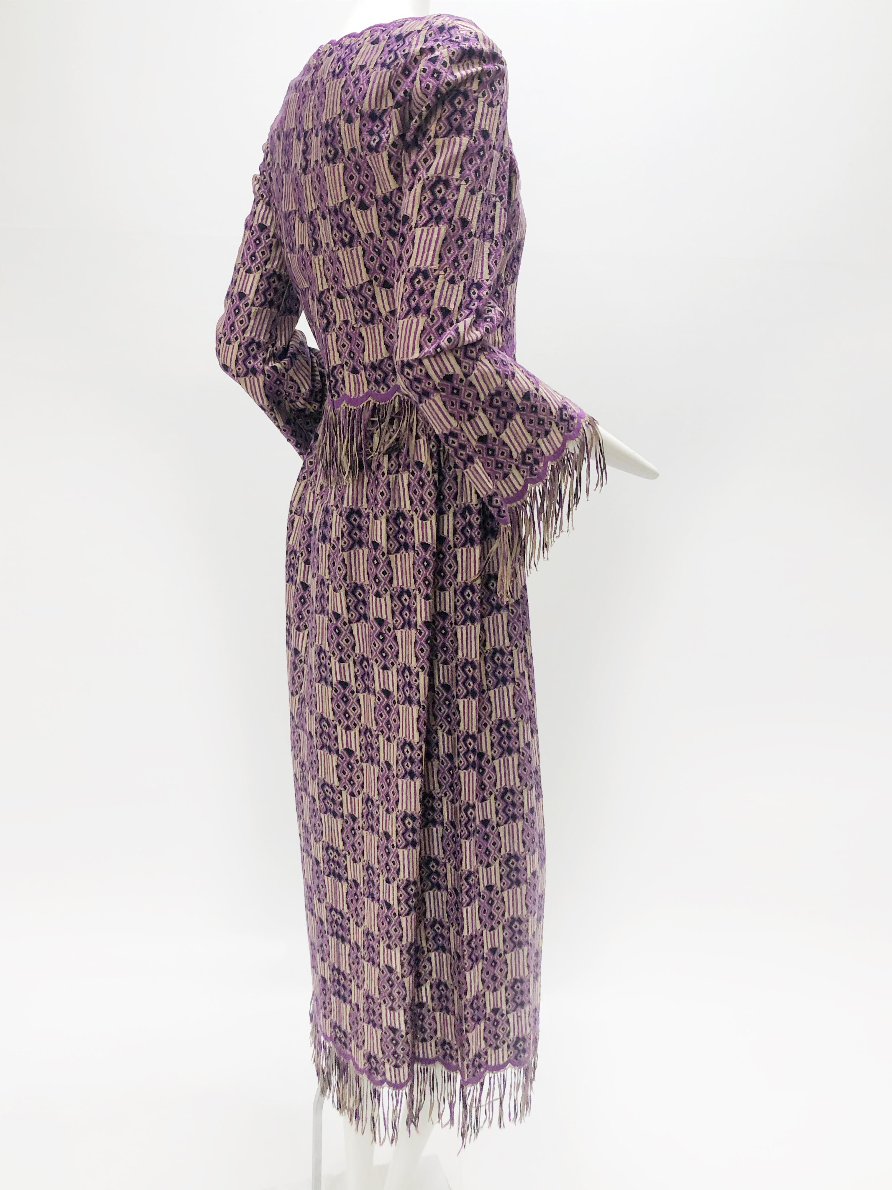 A wonderful late 1960s Christian Dior ethnic-inspired purple, black and tan light-weight knit maxi dress with free floating top overlay, scalloped and fringed sleeves, midriff and hem. Zippered back Size 6. Two pieces worn together. 
