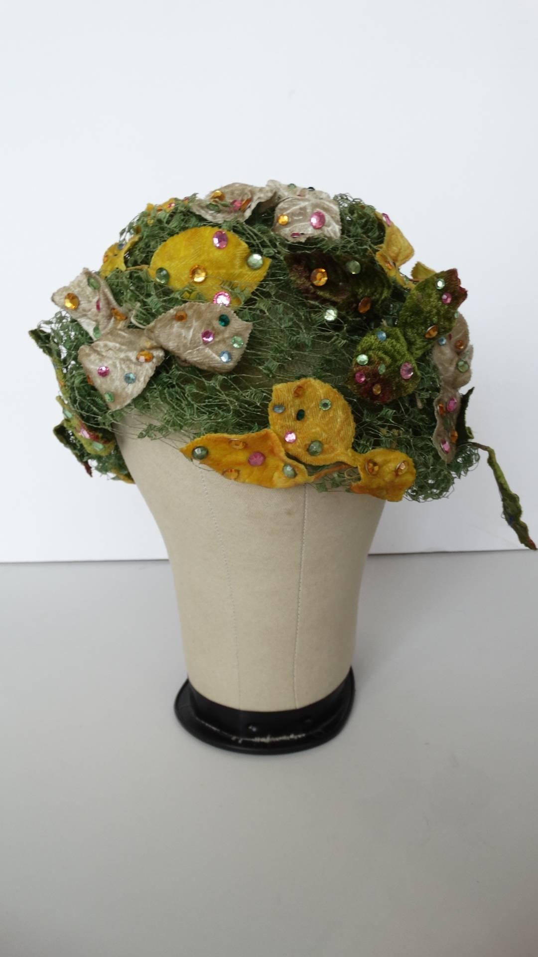 This is a original Christian Dior Turban designed for Cherry & Webb.  This hat is constructed with green tule the leaves covered in multi colored rhinestones. Beautiful for a garden party or just because! Made in France sz Meduim 21 inches in