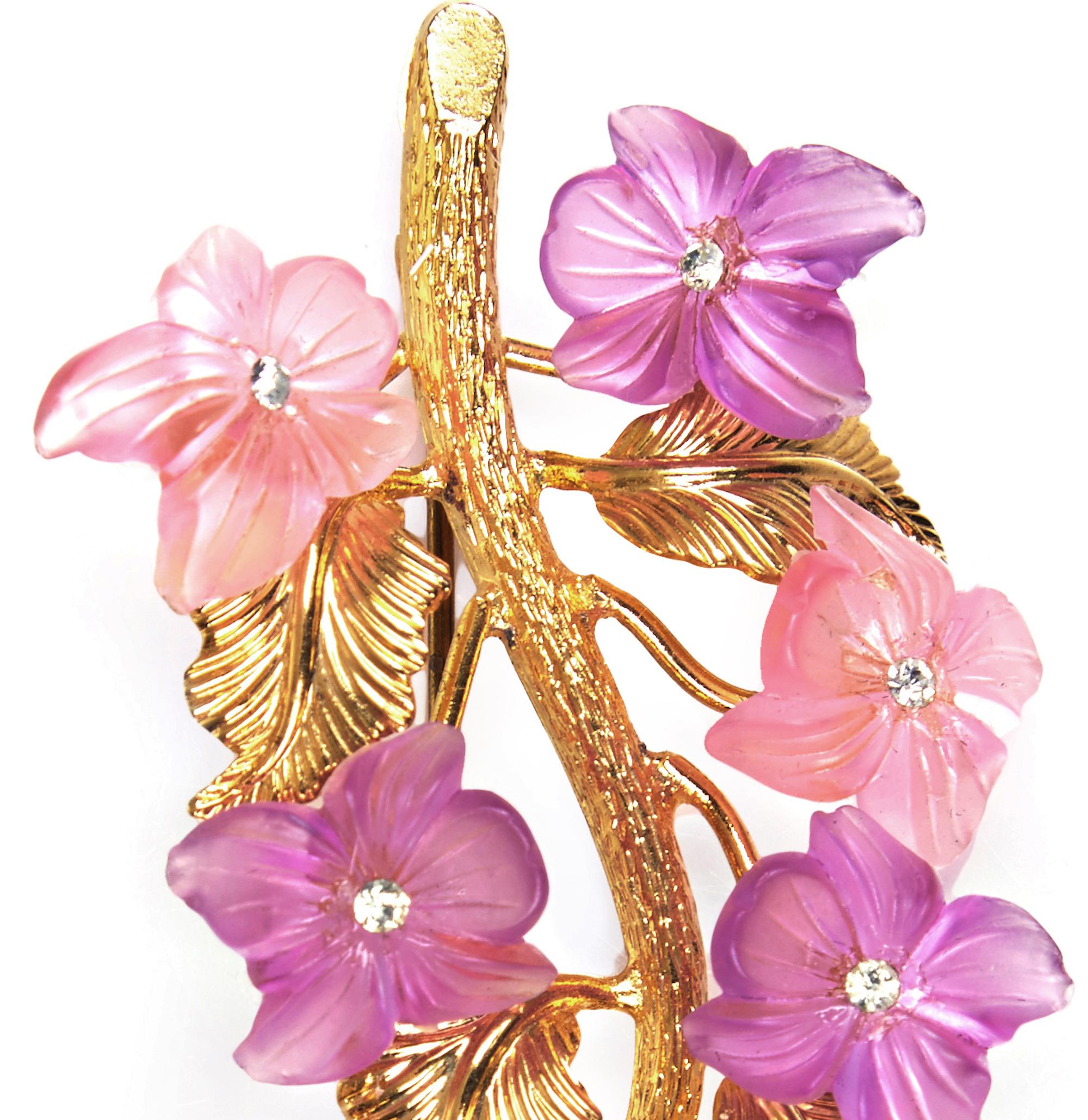 A rare vintage gold plated Christian Dior floral spray brooch manufactured by Henkel & Grosse in Germany and dated 1968.  The design is molded pink and violet coloured floral shaped glass with central crystal rhinestones, which gives a rich texture