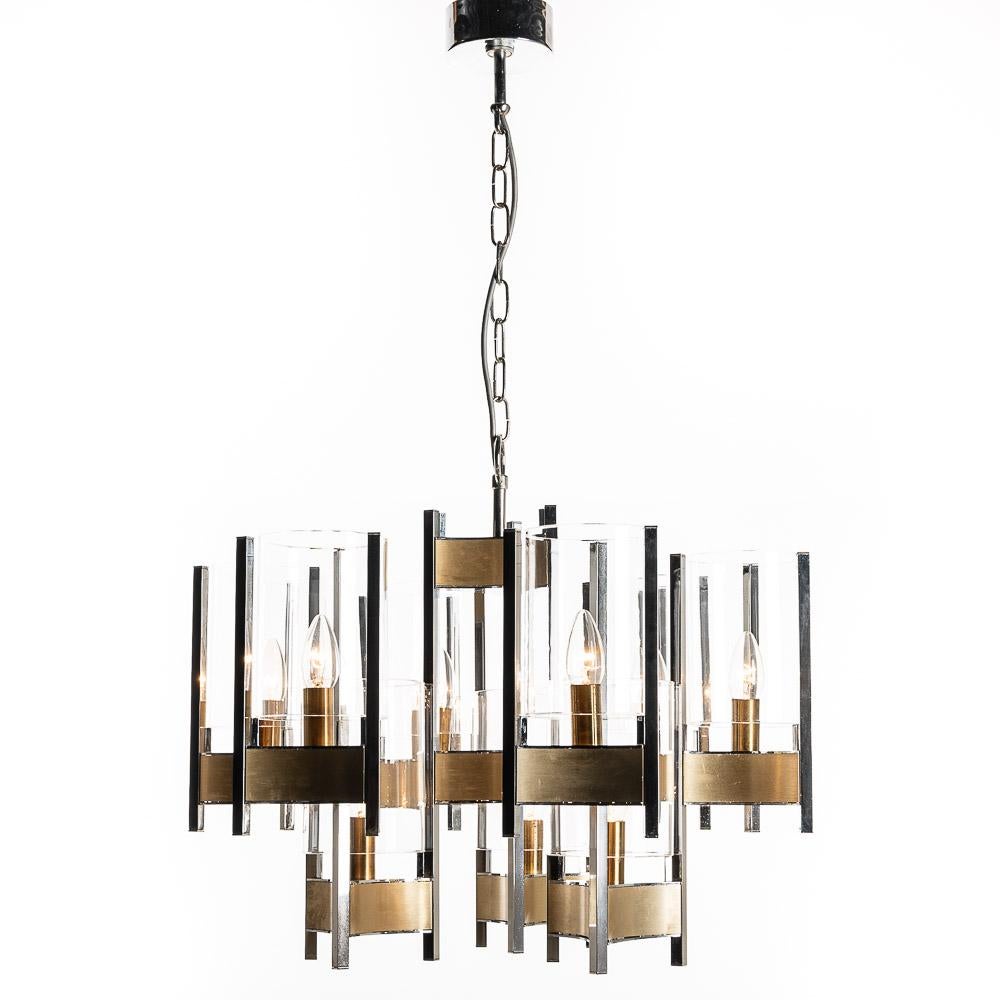 Gaetano Sciolari monumental chrome and brushed brass nine-light chandelier with cylindrical glass shades. From the Hurricane series. We have two pieces slight differences in wear.