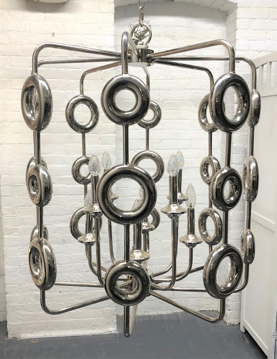 1960s chrome circular light fixture / chandelier. This light fixture is well designed with a multitude of round chrome circular disks on supported rods.