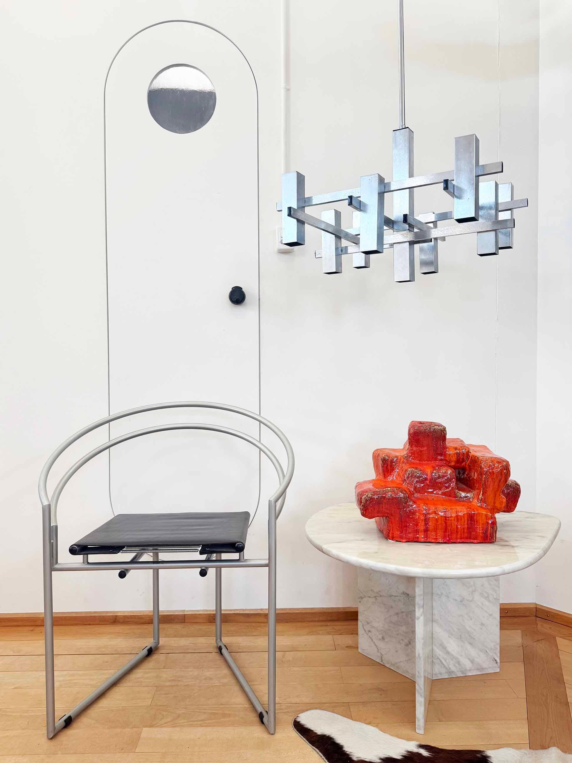1960s Italian chandelier featuring a Mid Century Geometric, Brutalist, Cubist, Modernist design and a chrome framework, designed by Gaetano Sciolari. 

This chandelier is equipped with 9 small bulbs that have downward-facing sockets. 

Dimensions: