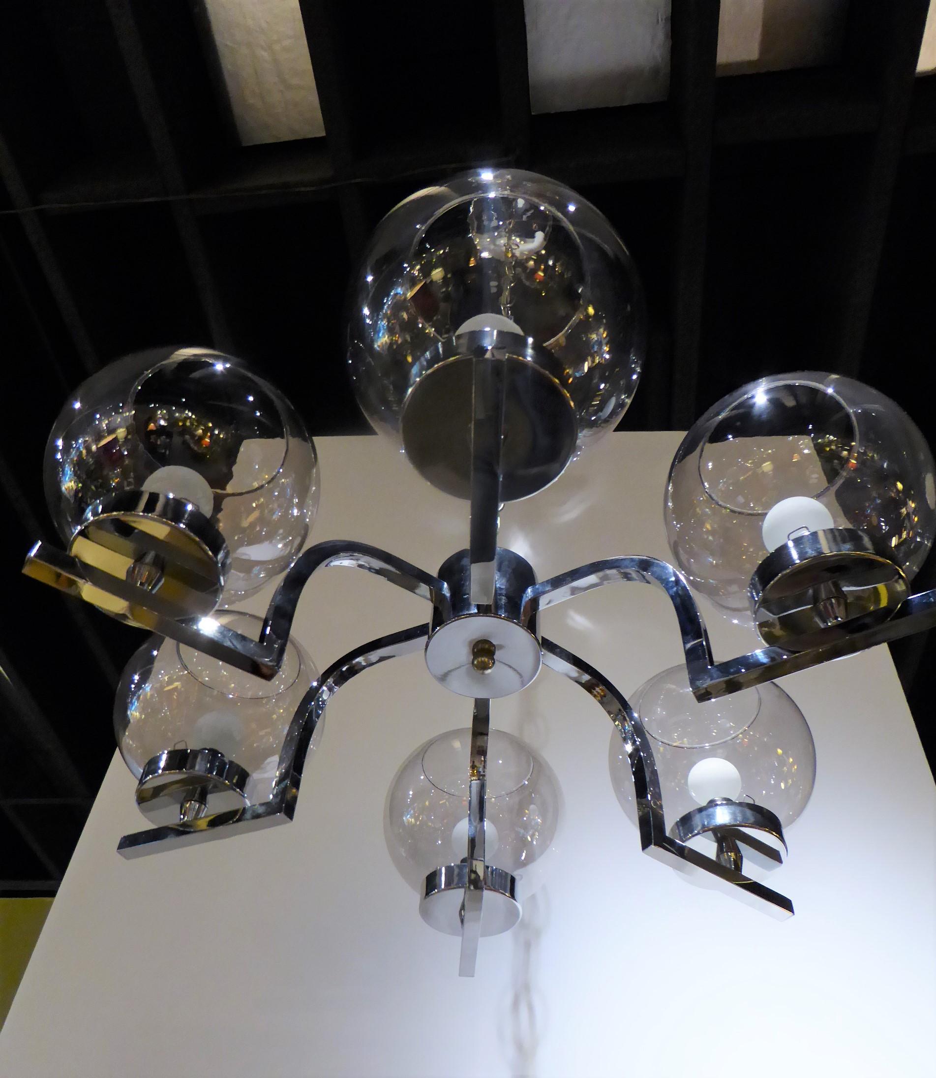 A 1960s chrome and smoked glass ball globe six-light chandelier with a radiating star or spider shape, down turning and out arms ending under blown smoked glass ball shaped globes. Bright and shiny chrome throughout, rewired and with new UL sockets.
