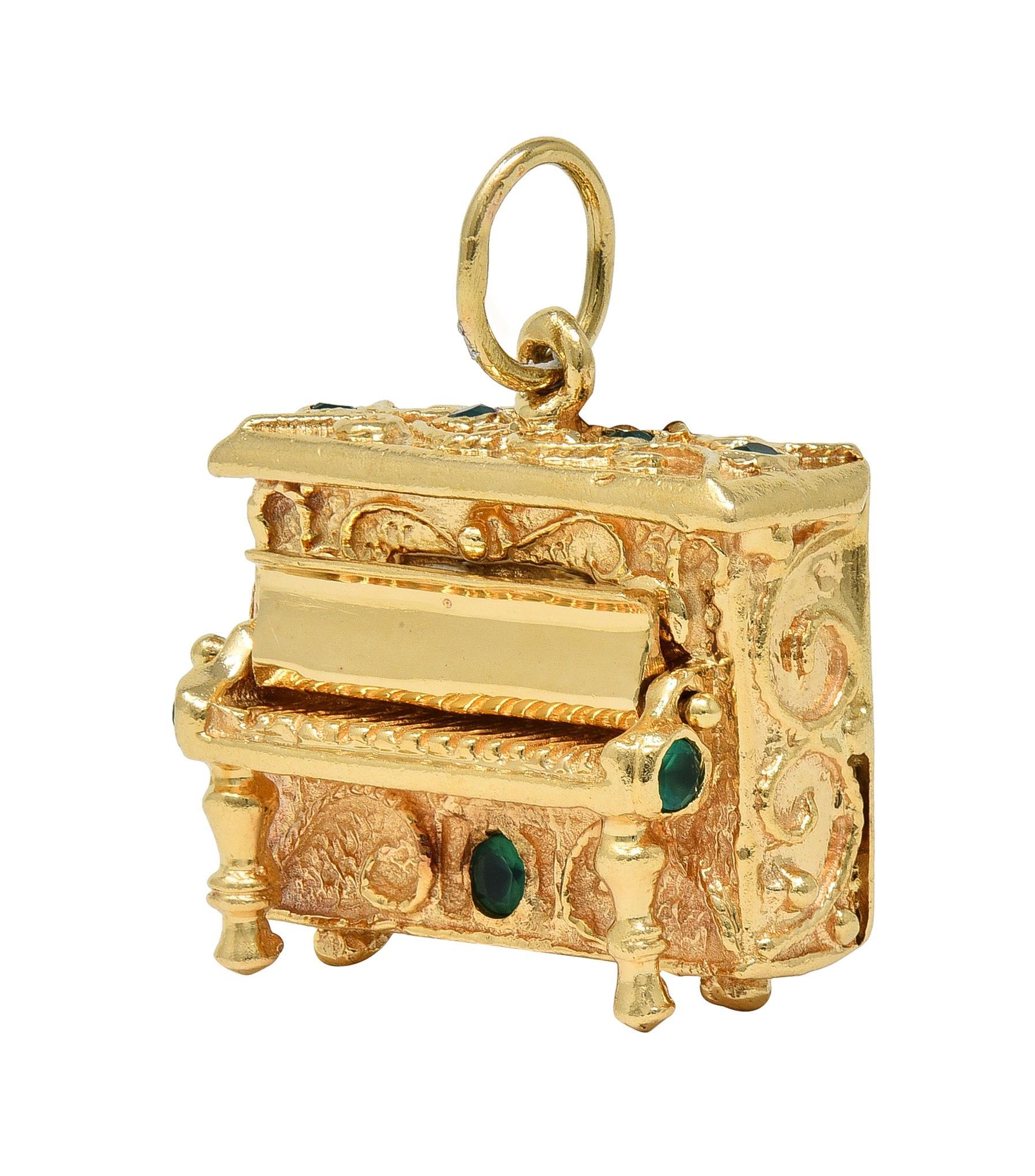 Designed as a highly rendered upright piano with functioning hinged key cover
Grooved with organic texture texture and scrolling filigree throughout
Accented by round cut chrysoprase flush set throughout
Transparent vibrant bluish green in