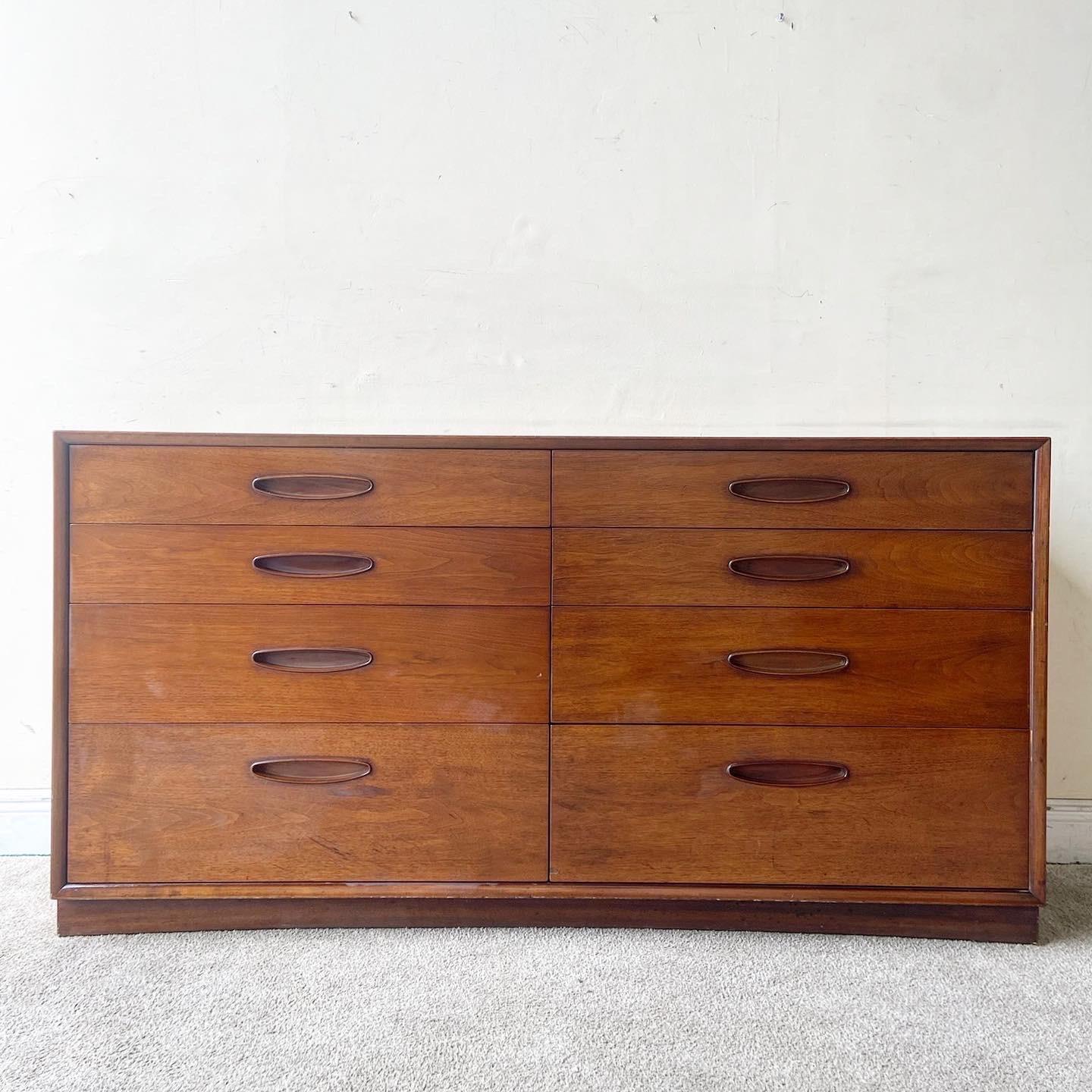 Exceptional Mid-Century Modern lowboy dresser by Henredon. Features an inlayed veneer over the top with fabulous symmetrical drawer handles.
 