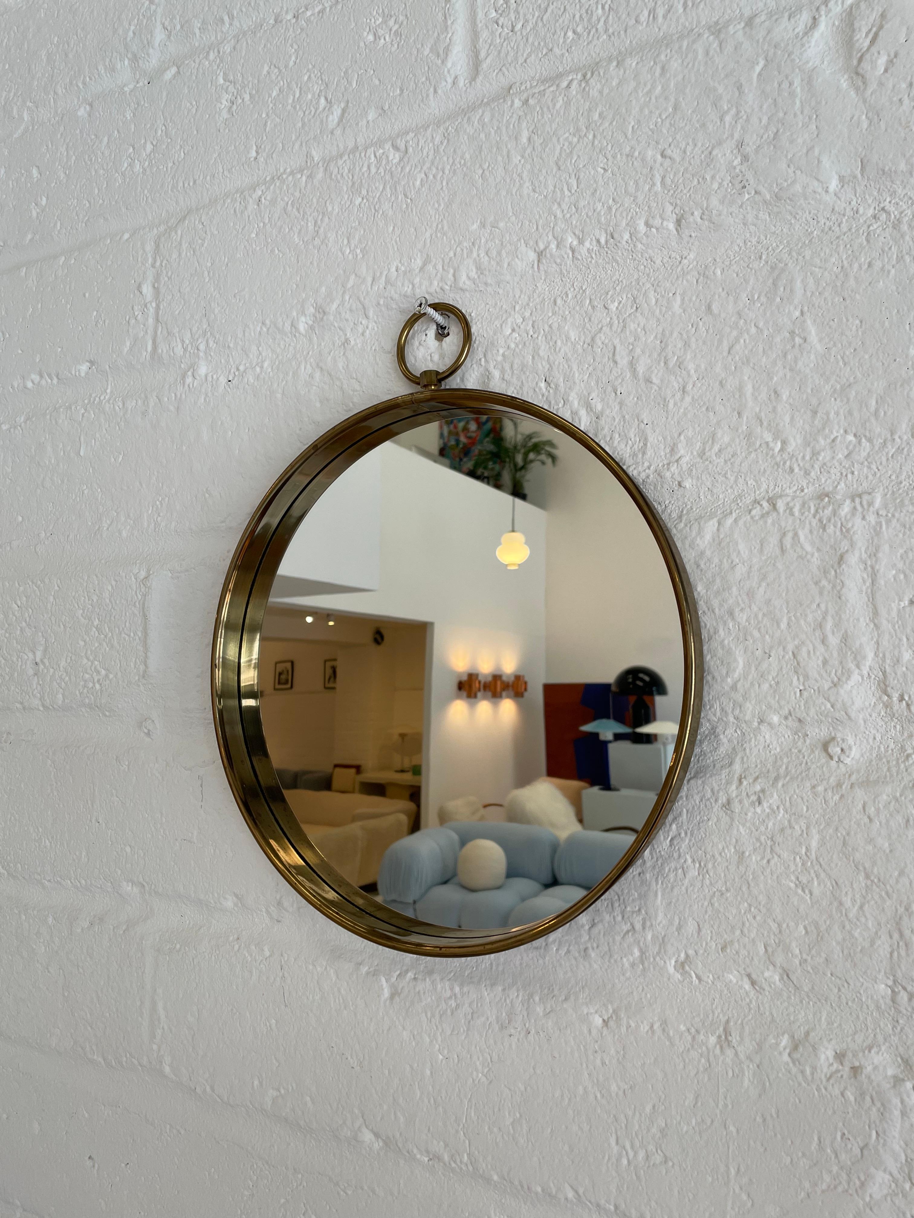 Diameter: 30cm

Date: 1960s
Materials: Brass, Glass 

Description: The 1960s circular brass wall mirror is a retro-inspired piece that epitomises the sleek and glamorous design of the 1960s era
