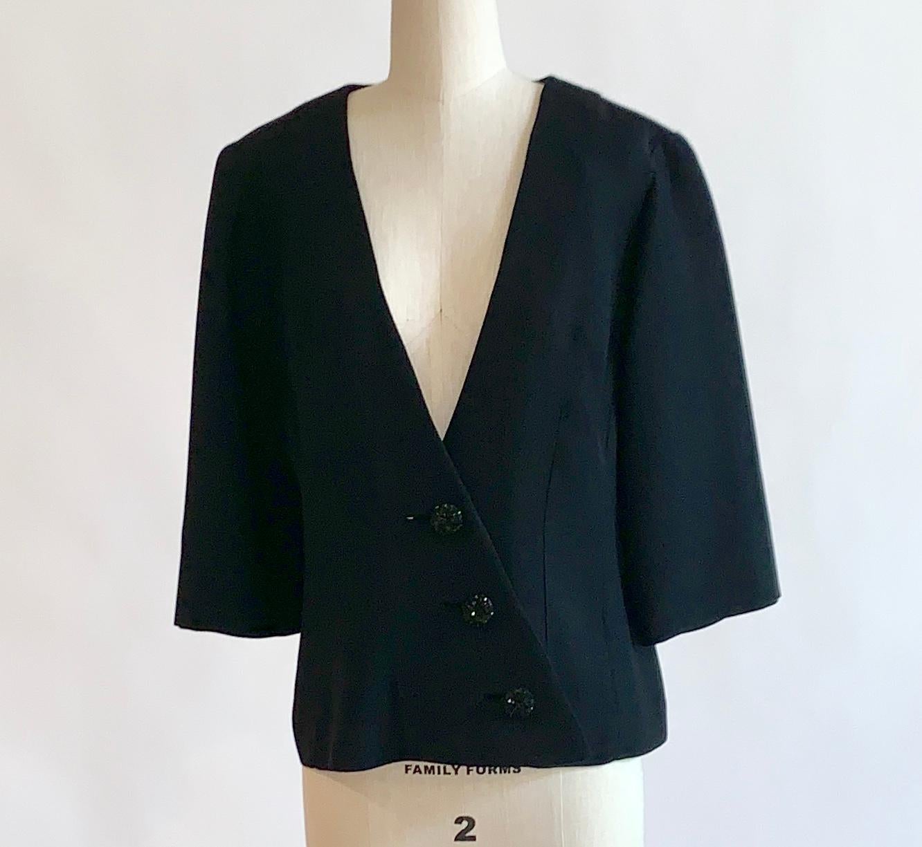 1960s Claralura Originals black jacket with wide sleeves, diagonal crossover closure and bead embellished buttons. Wide sleeve hits between elbow and wrist. 

No content label, feels like an acrylic crepe. 

No size label, best fits a S/M
Bust