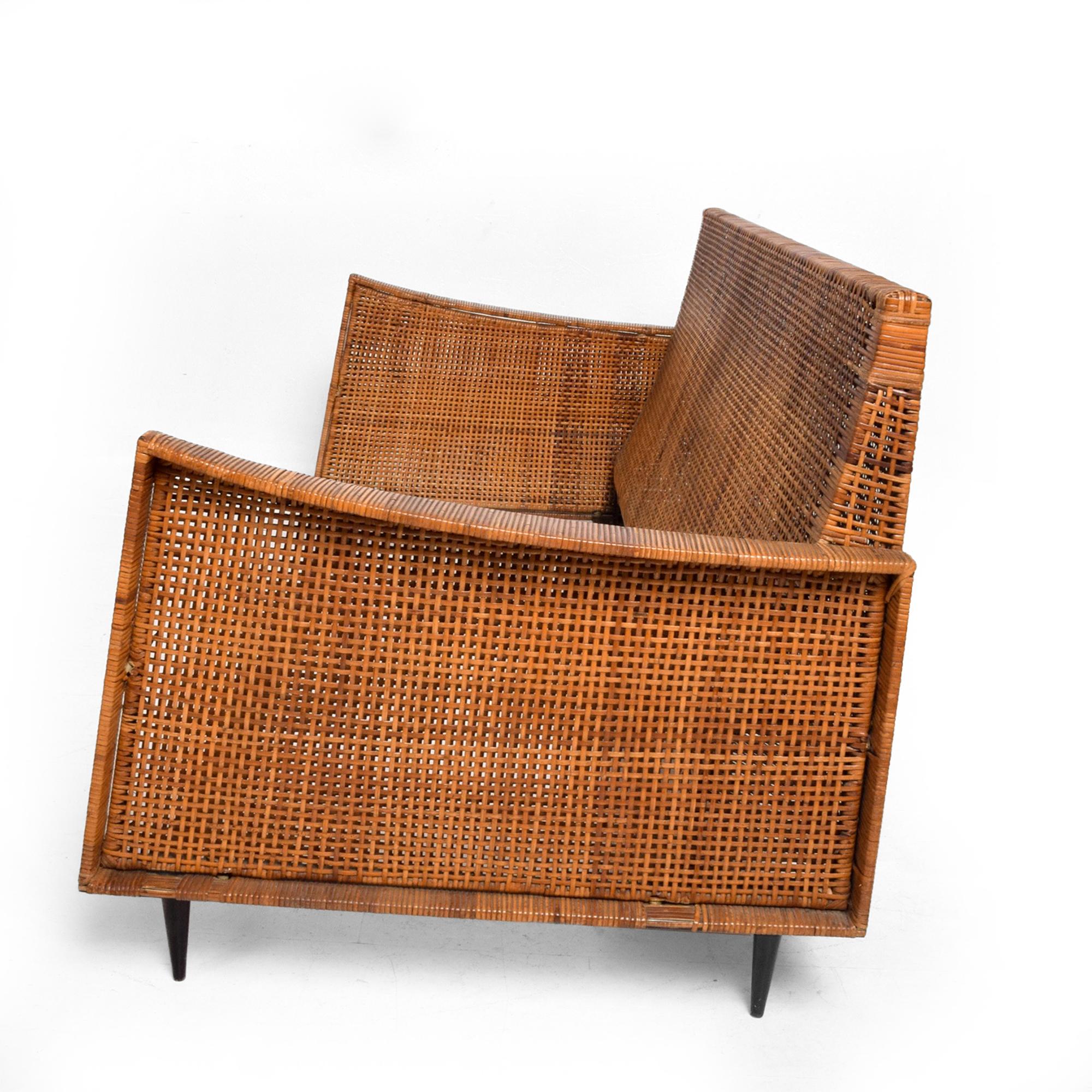 Vintage modern Cane loveseat sofa settee (material woven wood wicker)
Mexico, circa 1960s
Attribution to midcentury Mexican Modernist Arturo Pani.
Loveseat with pronounced clean sculptural lines -sits on a solid steel frame covered in cane-very