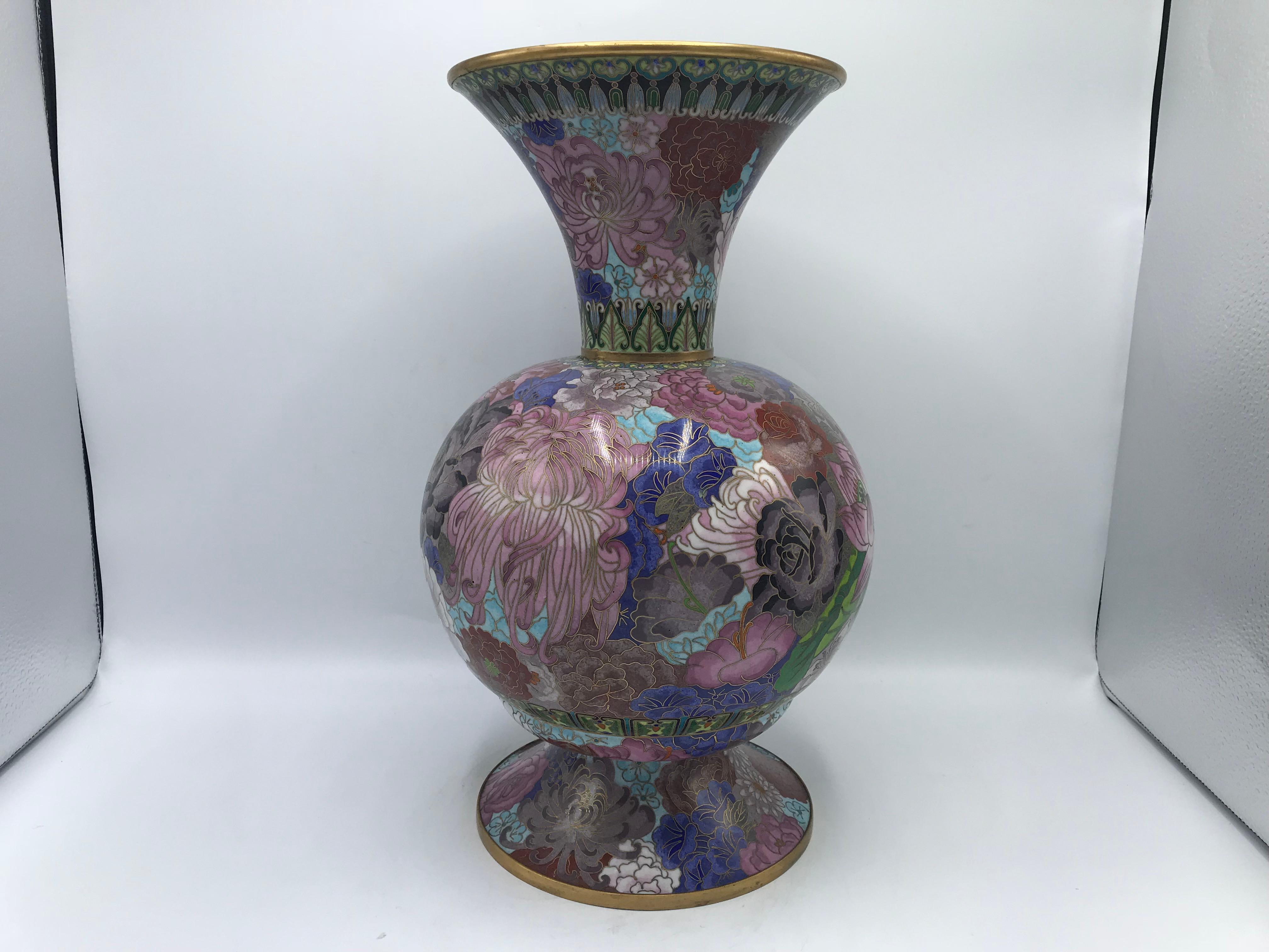 Listed is a fabulous, substantial 1960s Cloisonné vase. The polychromatic pink hues sets a perfect backdrop color for the purples, reds, blues, greens, and blacks mixed in. Truly a gorgeous piece.