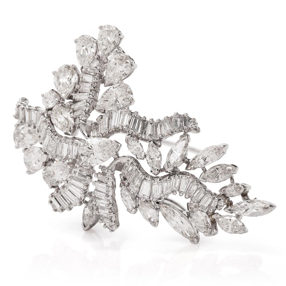 This botanically inspired swirl diamond brooch is crafted in solid platinum, weighing 20.4 grams and measures 54mm long x 34mm wide. Channel-set with 72 baguette shaped diamonds, weighing approximately, 4.32 carats, graded G-H color and VS clarity.