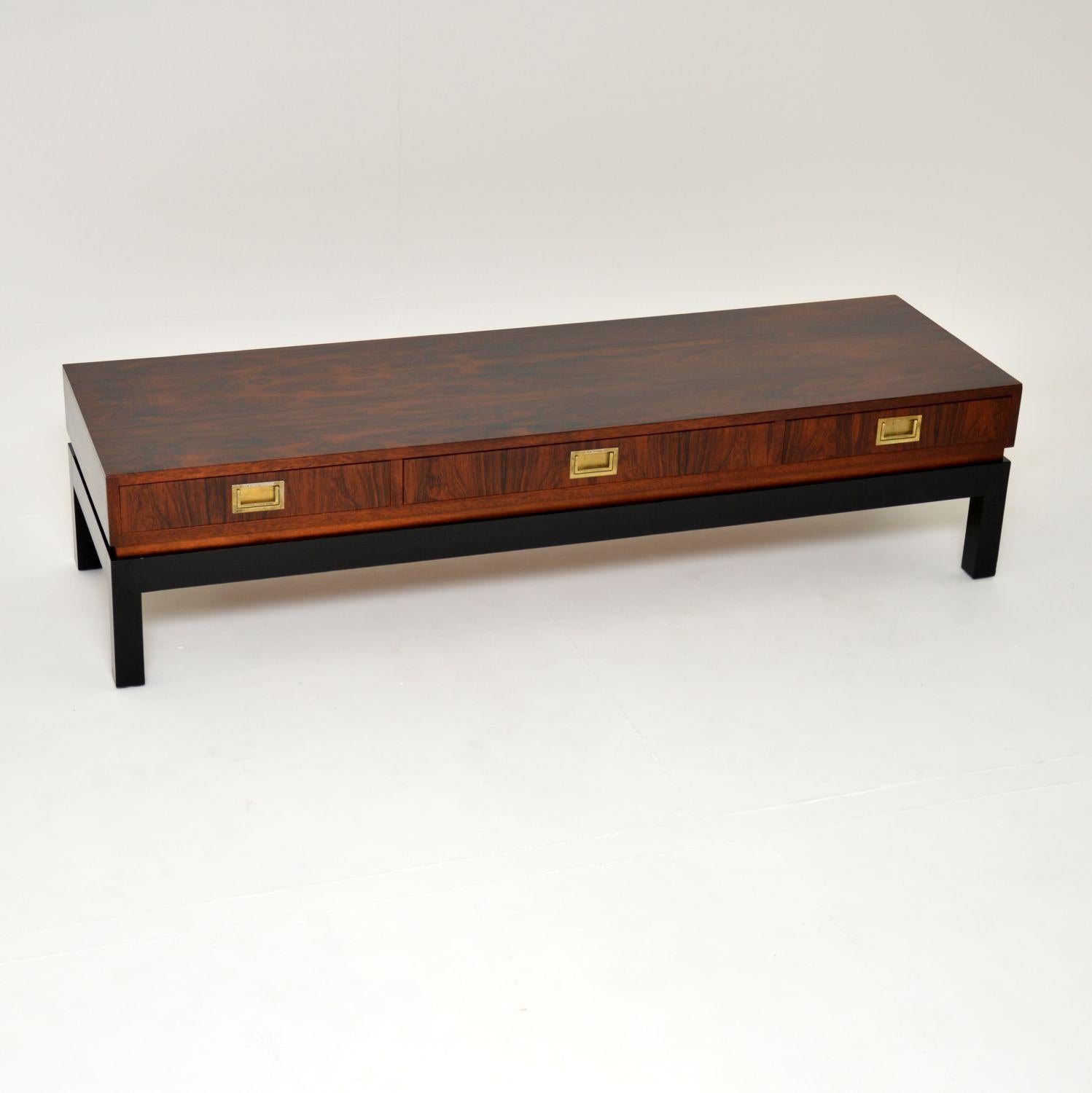 An absolutely stunning and very rare coffee table. This was made in England by Greaves and Thomas, it dates from the 1960’s.

The design is fabulous, it is low and long, with three double sided drawers that run all the way through and open on both
