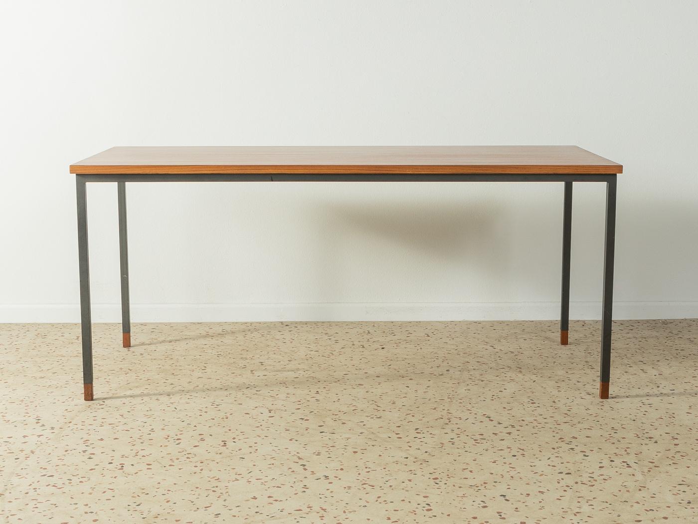 Classic teak coffee table from the 1960s. Squared steel frame with wooden feet and teak veneered table top.

Quality features:
 Very good workmanship
 High quality materials
 Made in Germany. Designer: Wilhelm Renz, frame manufacturer :