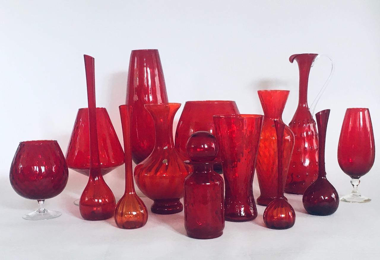 Vintage Midcentury Design Period Collection of 14 Deep Red Glass Vases and Decanters. All are made in the 1960's time period. Made in Italy, Empoli region and Germany. All are in a deep red glass. They all come in very good condition. On the small