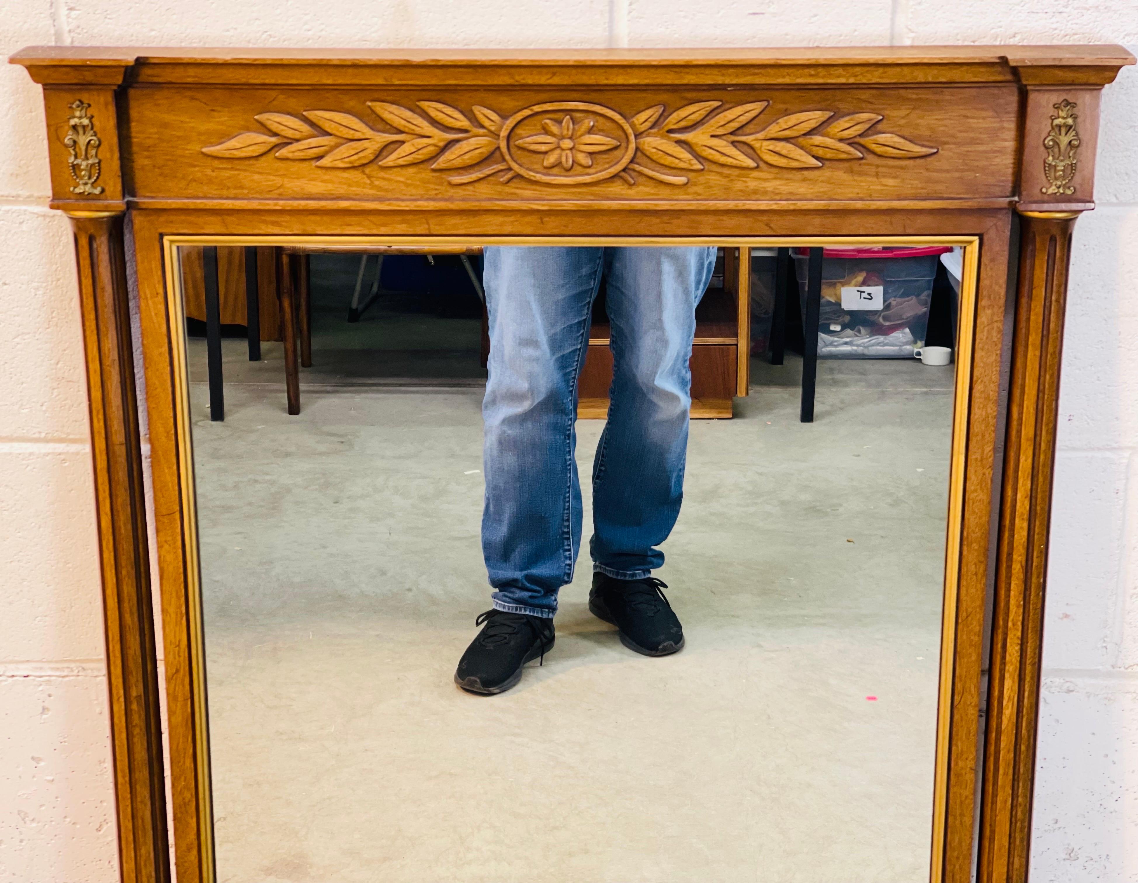 Vintage 1970s wall mirror with column accents and gold leaf design. The mirror is in elm wood and has gold accents around all edges. Hooks provided. No marks.