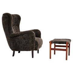 1960s, completely reupholstered Danish armchair with footstool, sheepskin.