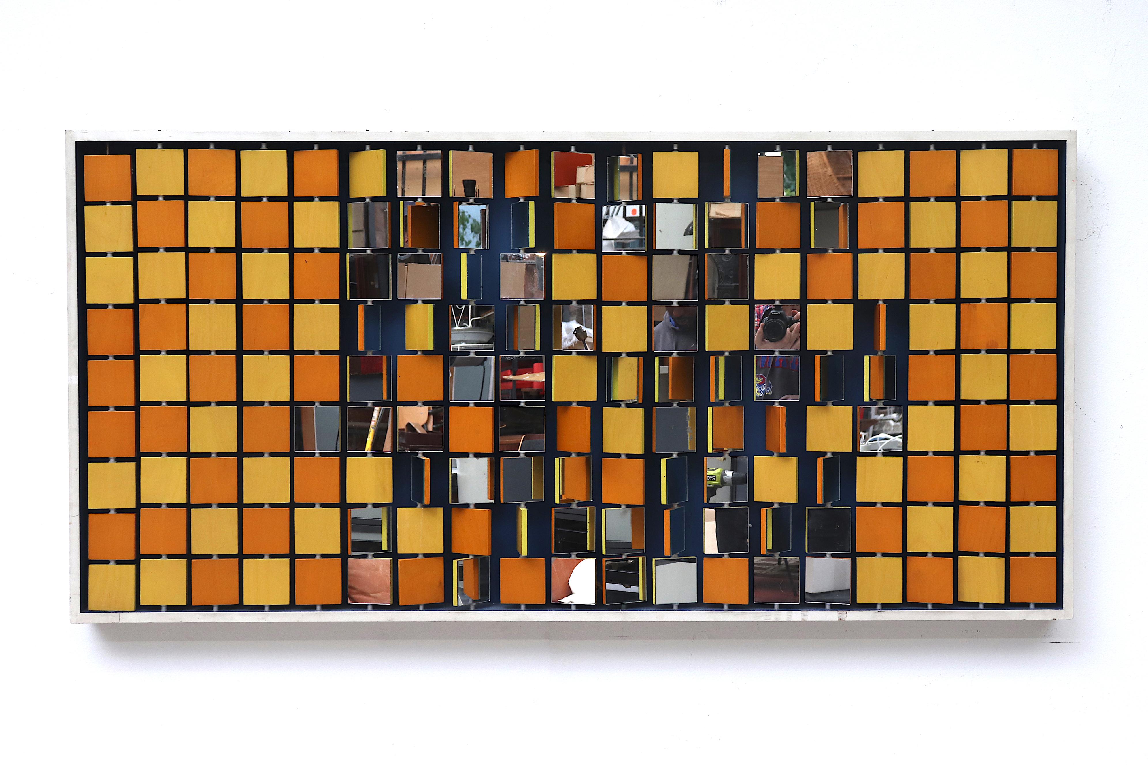 Amazing 1960s conceptual wall art with individual spinning yellow and orange painted wood squares with mirrored backs. In very original condition with visible wear and two mirrors are cracked.