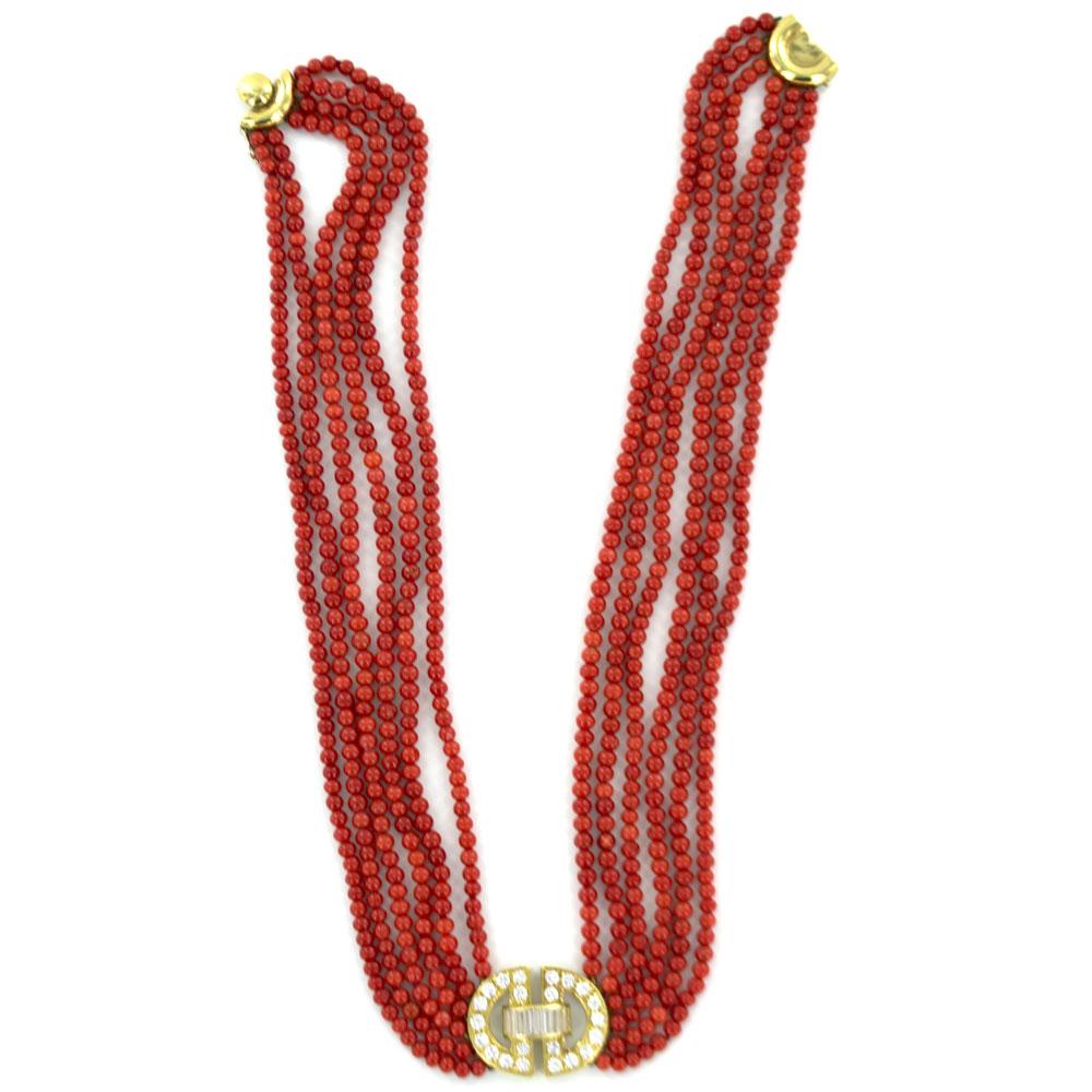 This stunning coral and diamond clasp necklace is circa 1960's. The coral strand necklace features a sparkling diamond clasp of baguette and round brilliant cut diamonds. There are a total of 3.00 carat total weight of diamonds. The clasp measures