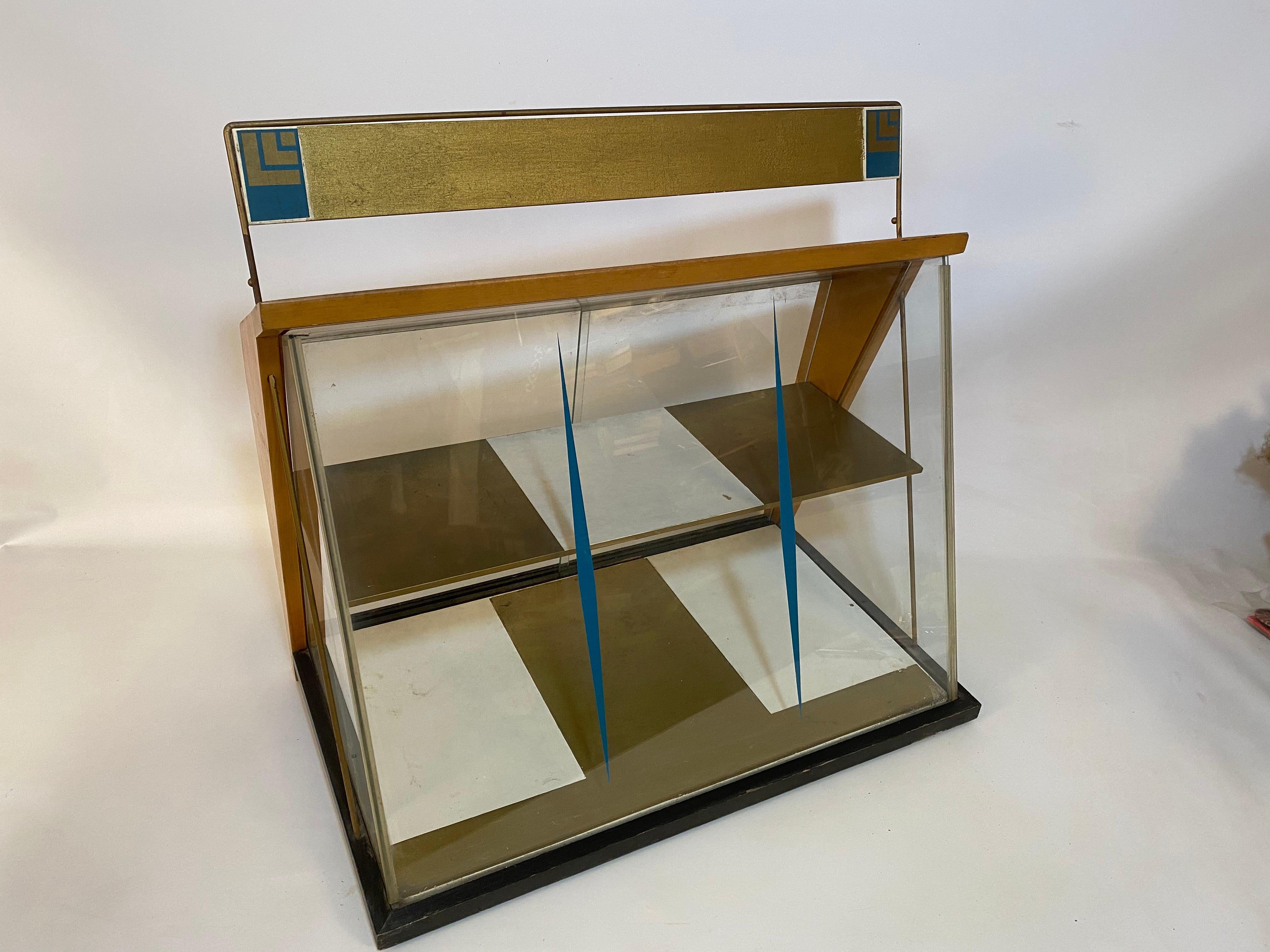 Amazing 1960s glass, wood and acrylic counter top display cabinet/showcase. A wonderful piece for your delicate items and collectibles. Glass front and side panels, painted wood shelves with two clear acrylic sliding doors. The interior is painted