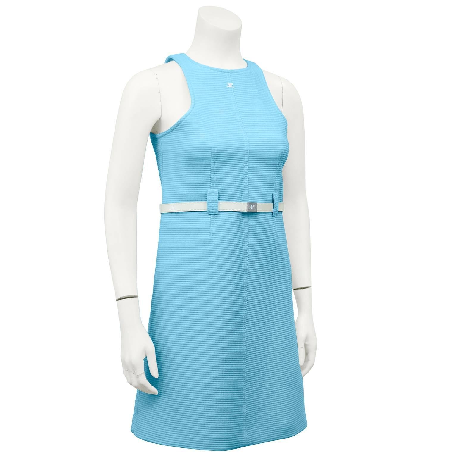 Adorable 1960s Courreges cotton baby blue ribbed day dress. Razor neckline with white embroidered Courreges logo. Belt loops and white patent loose fit leather belt at waist with sliver hardware and Courreges logo. Excellent vintage condition.