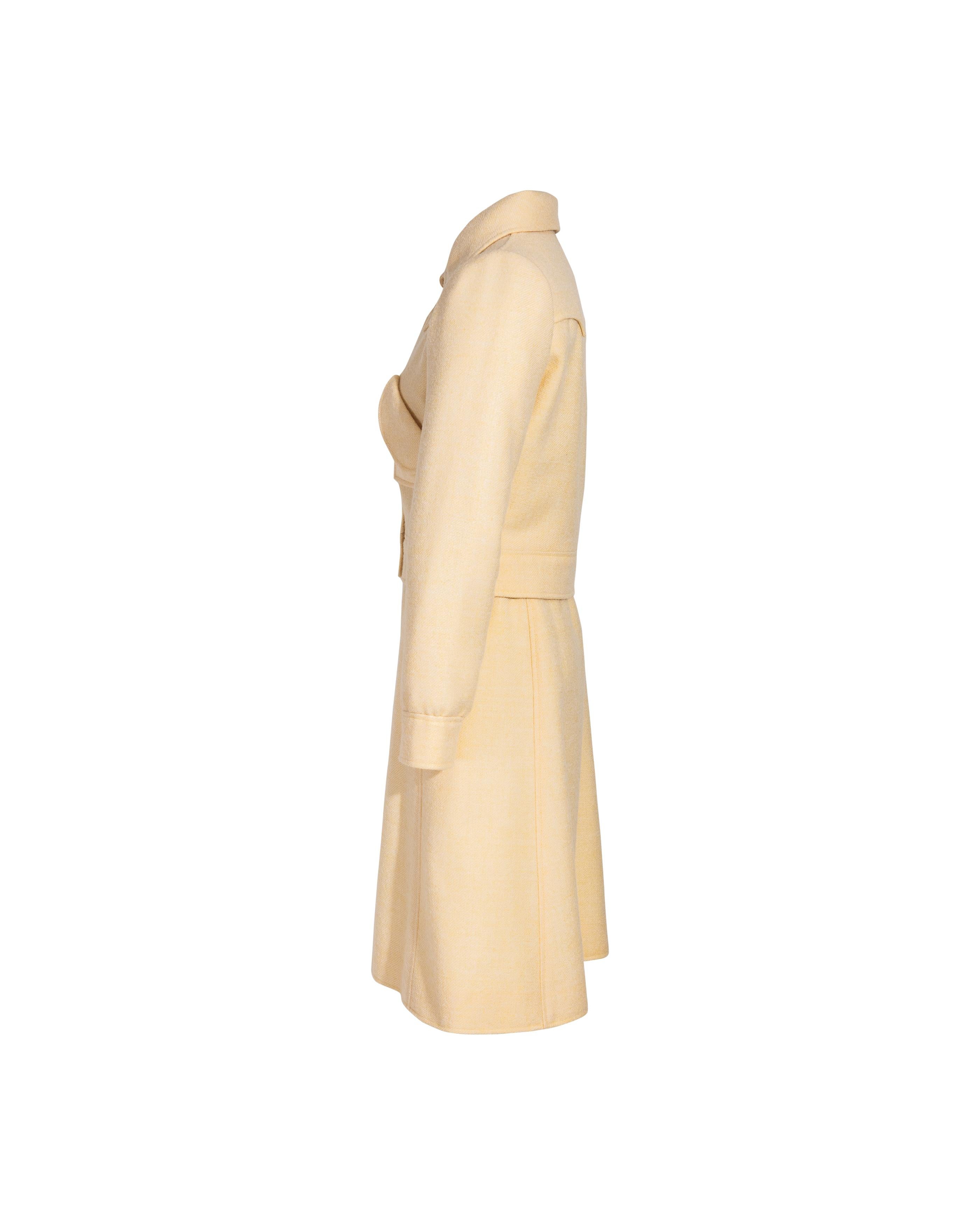 1960's Courreges pale yellow space age skirt set. Collared jacket with snap button closures and geometric oversized front pockets. A-line knee-length skirt with horizontal waist buttons and hidden side zip closure. 

Measurements

JACKET
Pit to Pit: