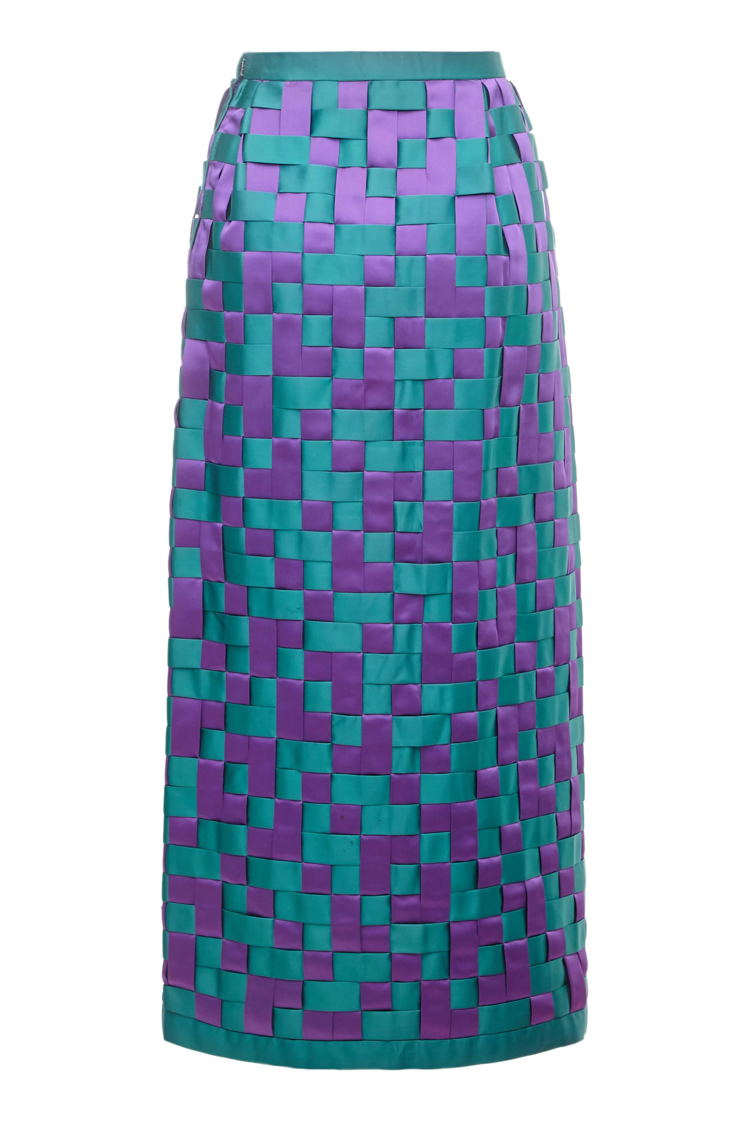 This exceptional 1960s hand woven satin couture skirt in purple and jade green is a fantastic statement piece in excellent vintage condition.  It fastens at the side with a zip, is fully lined in a green silk lining and is in excellent condition