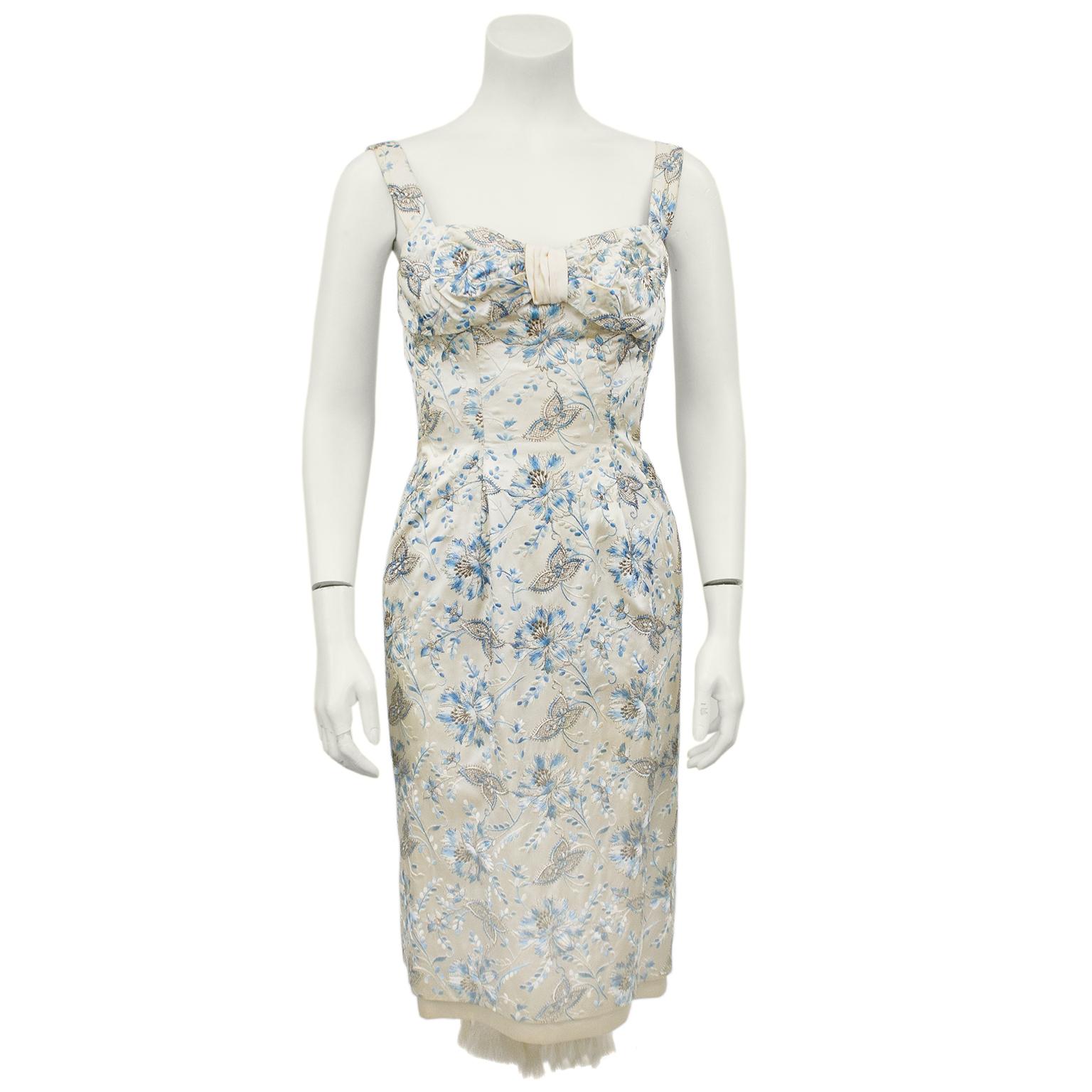 Early 1960's satin cocktail dress from Madrid based Spanish designer Varga Ichagaria. Beautiful blue floral all over floral embroidery, inspired by the DIor/Eisa evening look. Fitted bodice with a slight ruching detail at bust and pencil style