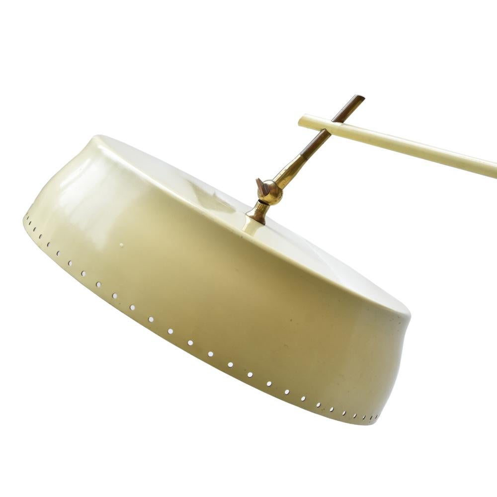 A 1960s floor light. Italian design by Angelo Lelli for his Arredoluce company in Monza, Italy. Cream and pastel green colored enameled aluminium shade with a brass articulated arm and structure on a green marble round base.
The height of the arm