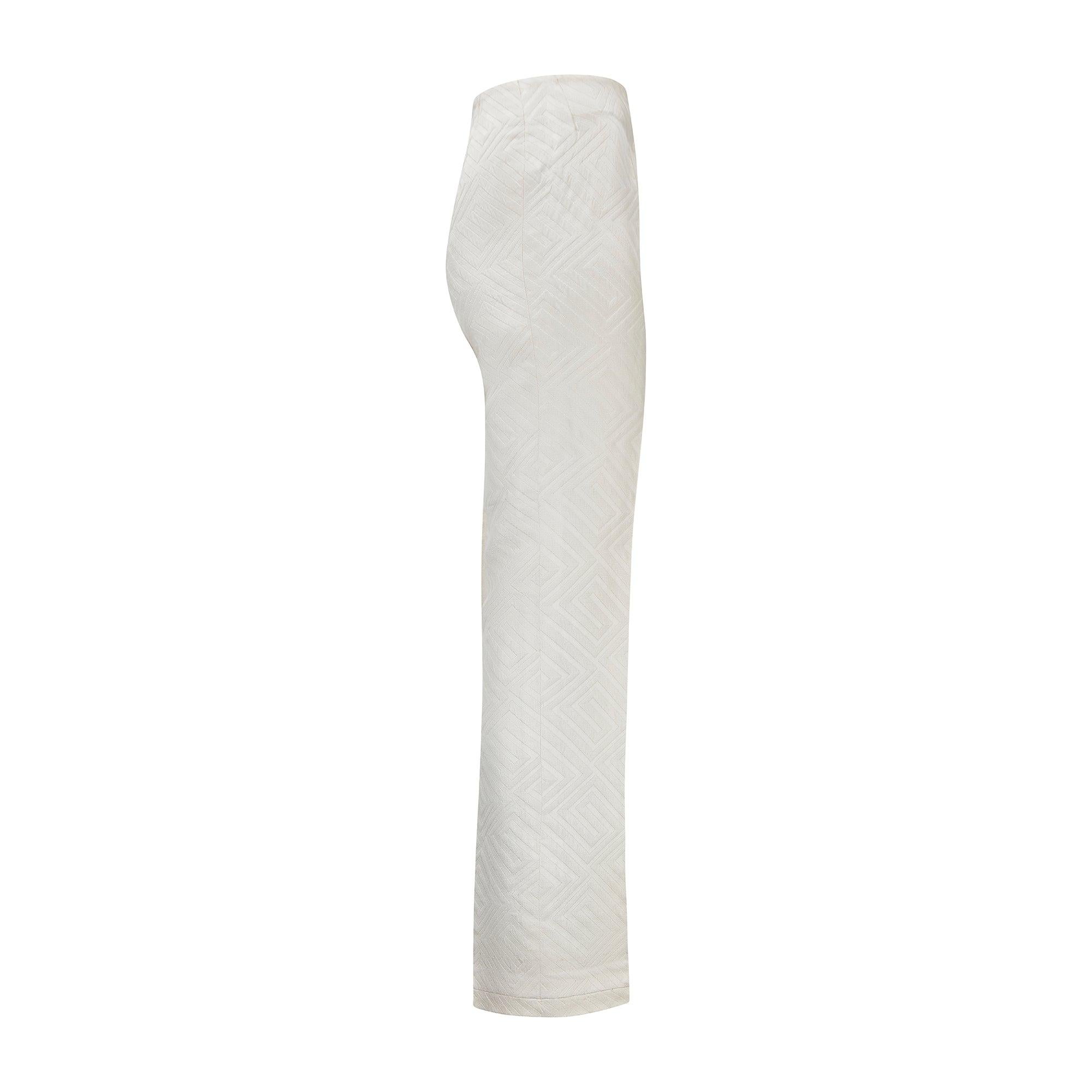 These chic 1960s trousers are tailored to a high-waisted fit with straight-legs. It is the fabric that truly sets these trousers apart; crafted from think cream jacquard, they showcase zig-zagging geometric forms woven to a 3D effect. The silhouette
