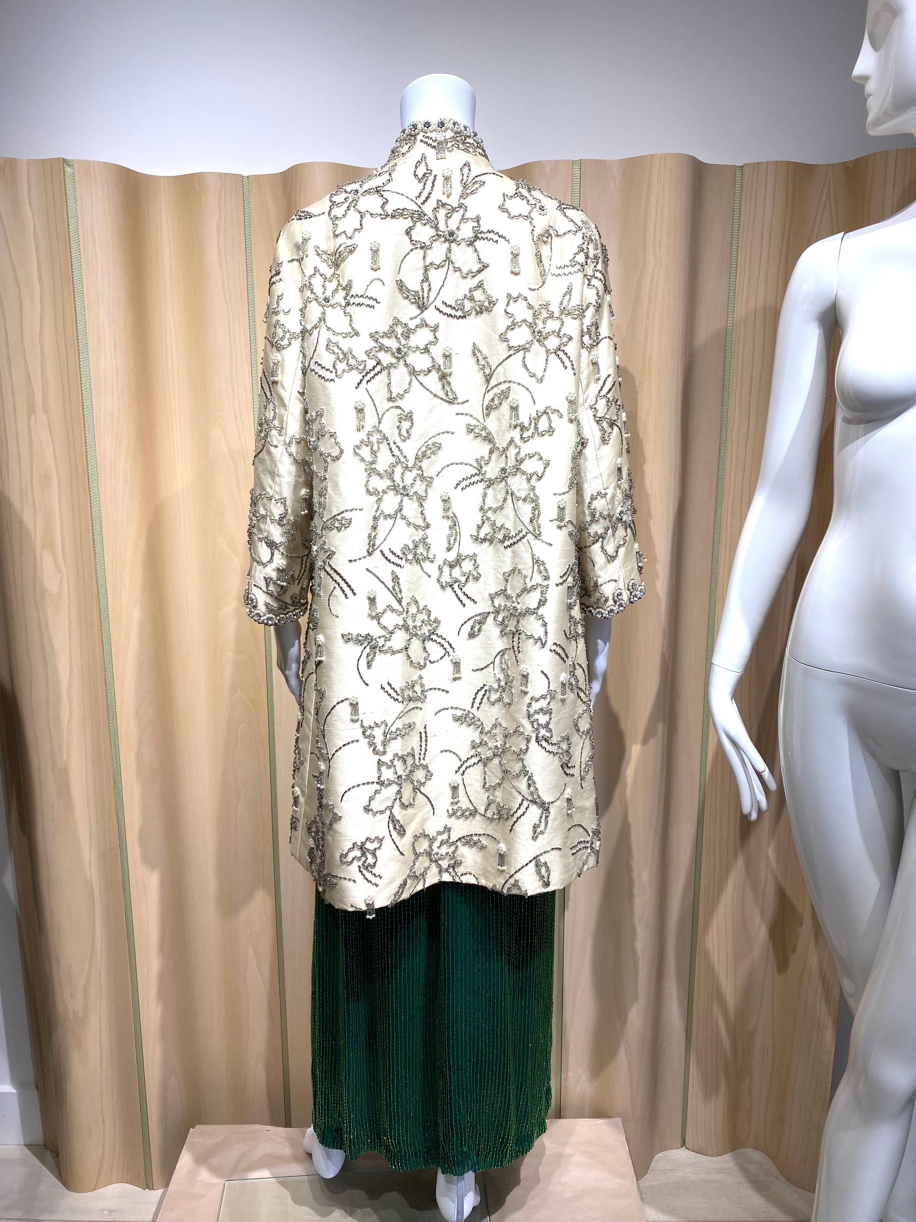 1960s Cream silk evening coat embellished in pearls and rhinestones. Perfect coat for wedding rehearsal or cocktail party.
Fabric : Silk
Size Large
Measurement:
