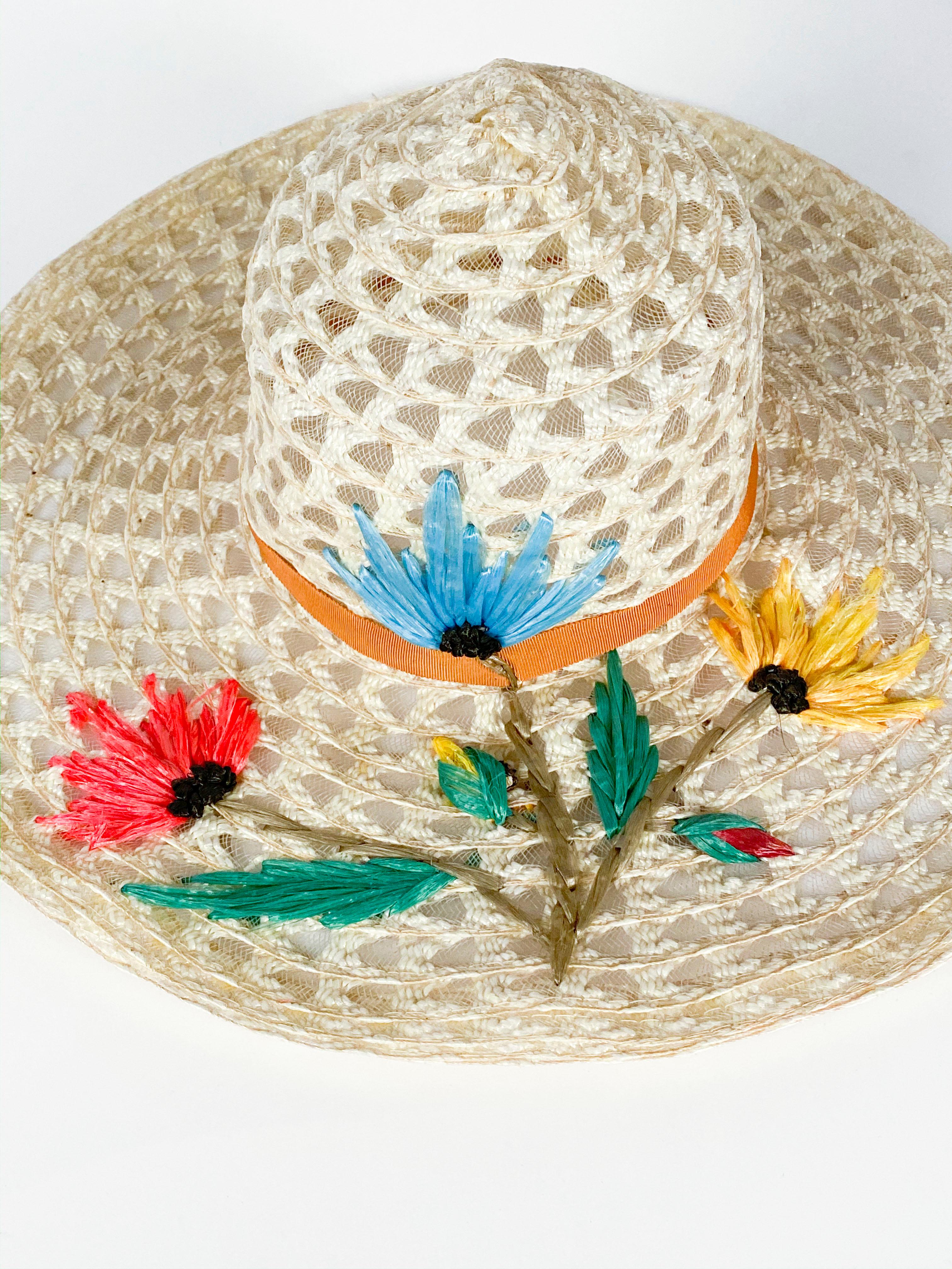 1960s Creme Raffia Beach Hat with Raffia Flower hand-embroidery in blue, pink and yellow finished with an orange gros-grain band.