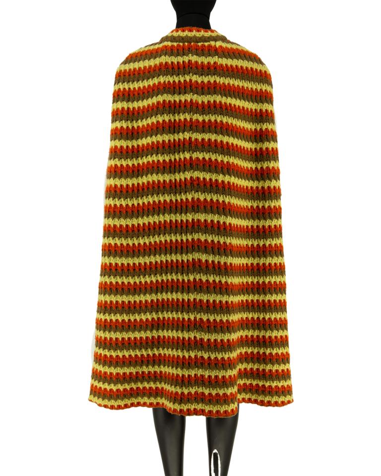 1960's crochet cape in orange, yellow and brown wool. Faux tortoiseshell button that fastens at the neck. 

Original 1960s. 
Excellent vintage condition.
 Marked size 12

Outerwear sourced by Stelios Hawa with the objective to bridge the gap between