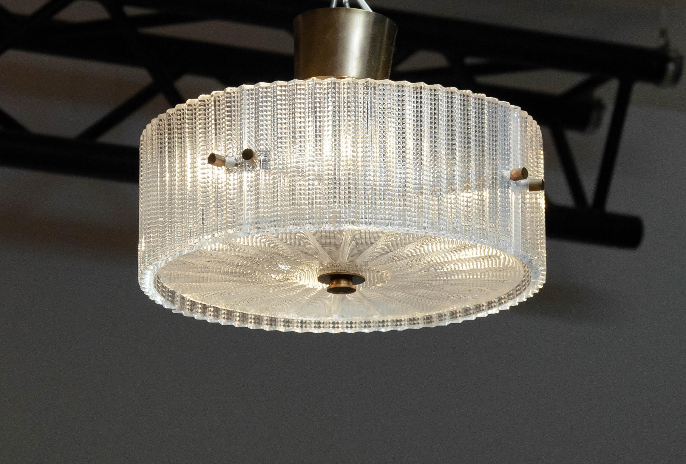 Mid century ceiling lamp / flush mount designed by Carl Fagerlund for Orrefors in Sweden.
The fixture is made of brass and supports four E28 screw fittings. 
All glass parts are in excellent and clean condition. The fixture as well as the wiring and