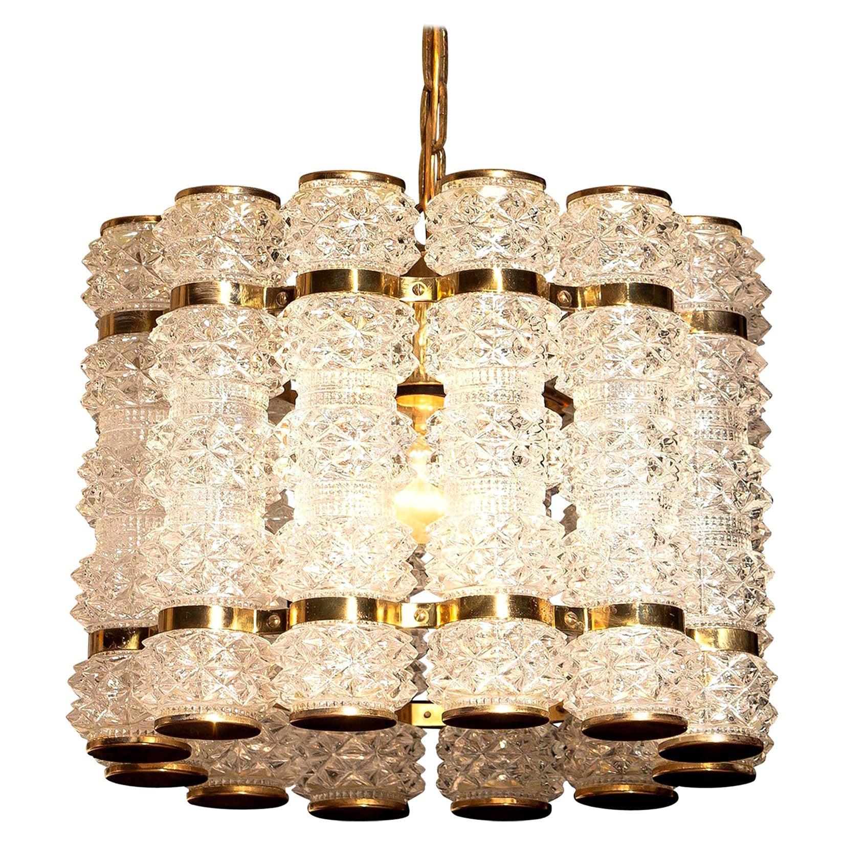 Beautiful and in perfect condition brass chandelier or pendant with twelve crystal cylinders.
Designed and manufactured in by Tyringe Konsthantverk, Sweden.
All crystal cylinders are made by Orrefors, Sweden.
Wired for 220 and 110 volts. Bulb