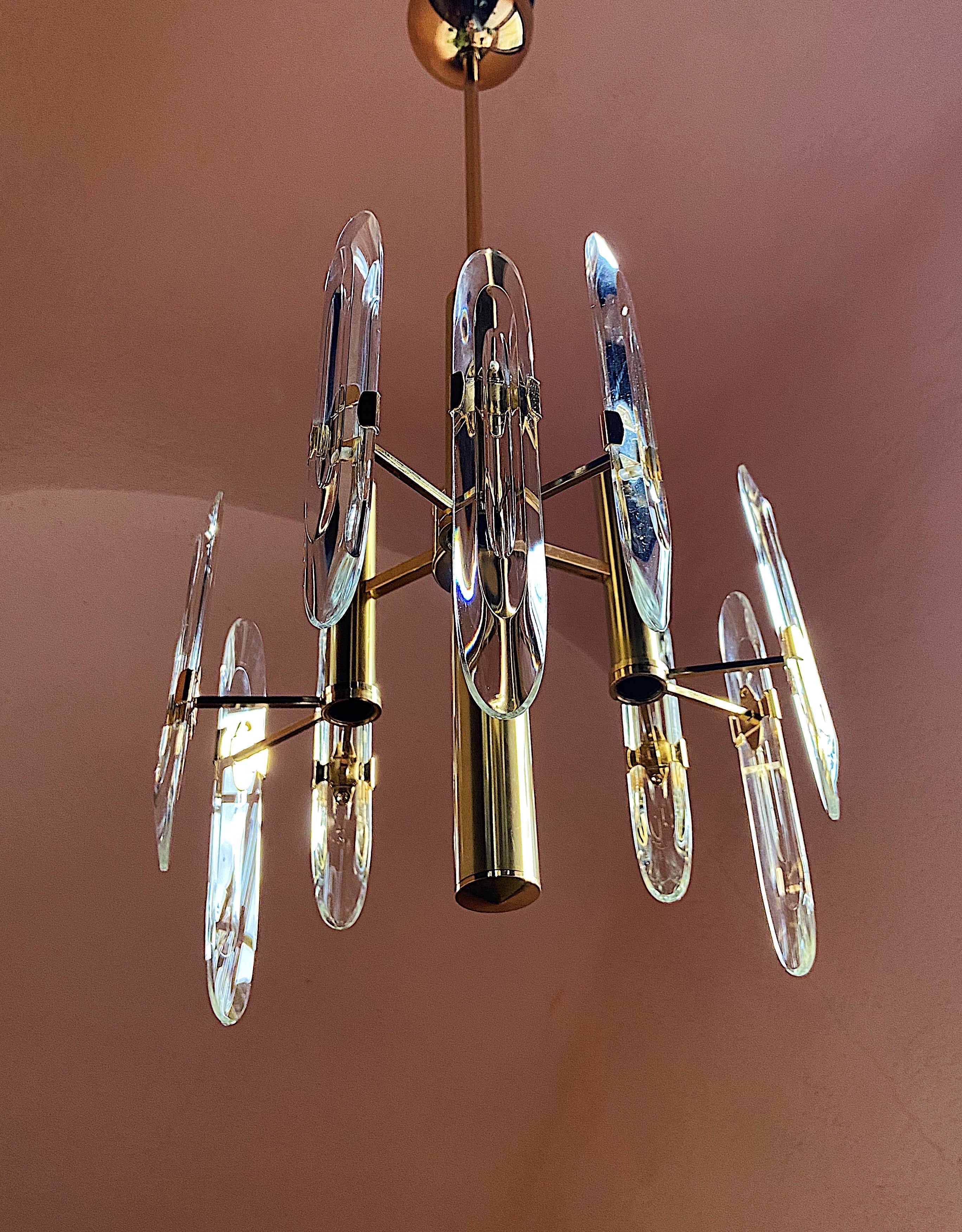 Gorgeous 3 armed chandelier by Gaetano Sciolari, 1970s, Italy.
9 crystal glasses set on a metal base. 3 light sockets.

Details
Creator: Gaetano Sciolari (Designer)
Dimensions: height: 95 cm width: 36 cm
Materials and Techniques: Chrome,