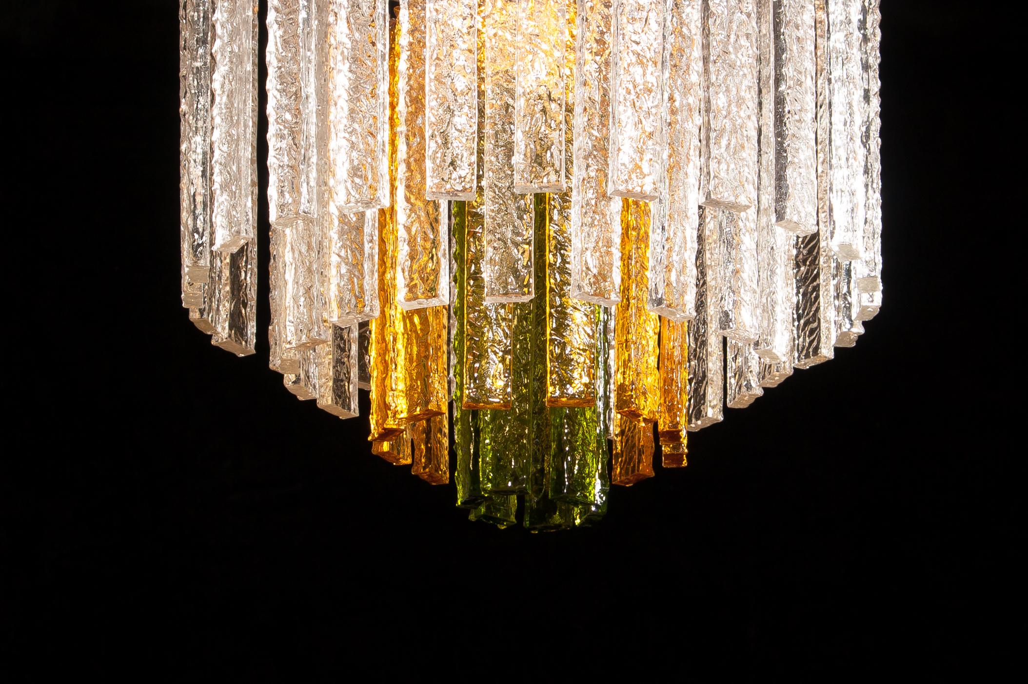 Amazing Murano Venini chandelier.
This wonderful lamp consists of a metal frame with 24 clear, 12 amber and 6 green Murano glass items.
It is in a beautiful and working condition.
Period 1960s
Dimensions: H 55 cm, ø 50 cm.