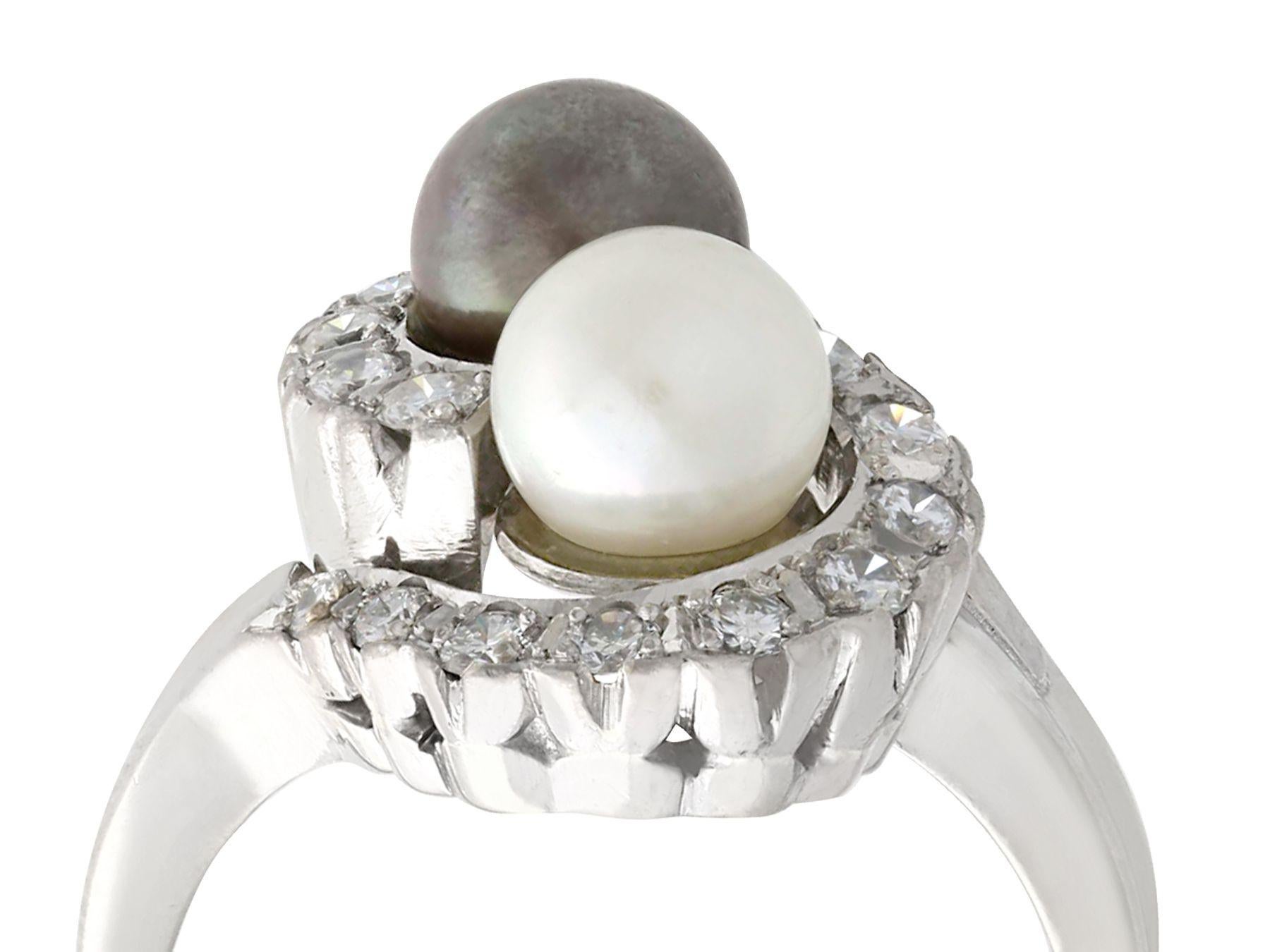 A stunning black and white cultured pearl, 0.95 carat diamond and 14 karat white gold twist style cocktail ring; part of our diverse vintage jewelry collections.

This stunning, fine and impressive white and black pearl ring has been crafted in 14k