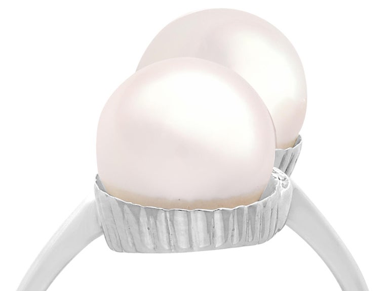 A fine and impressive vintage cultured pearl and 0.12 carat diamond, 18 karat white gold cocktail ring; part of our vintage jewelry and estate jewelry collections.

This fine and impressive pearl cocktail ring has been crafted in 18k white
